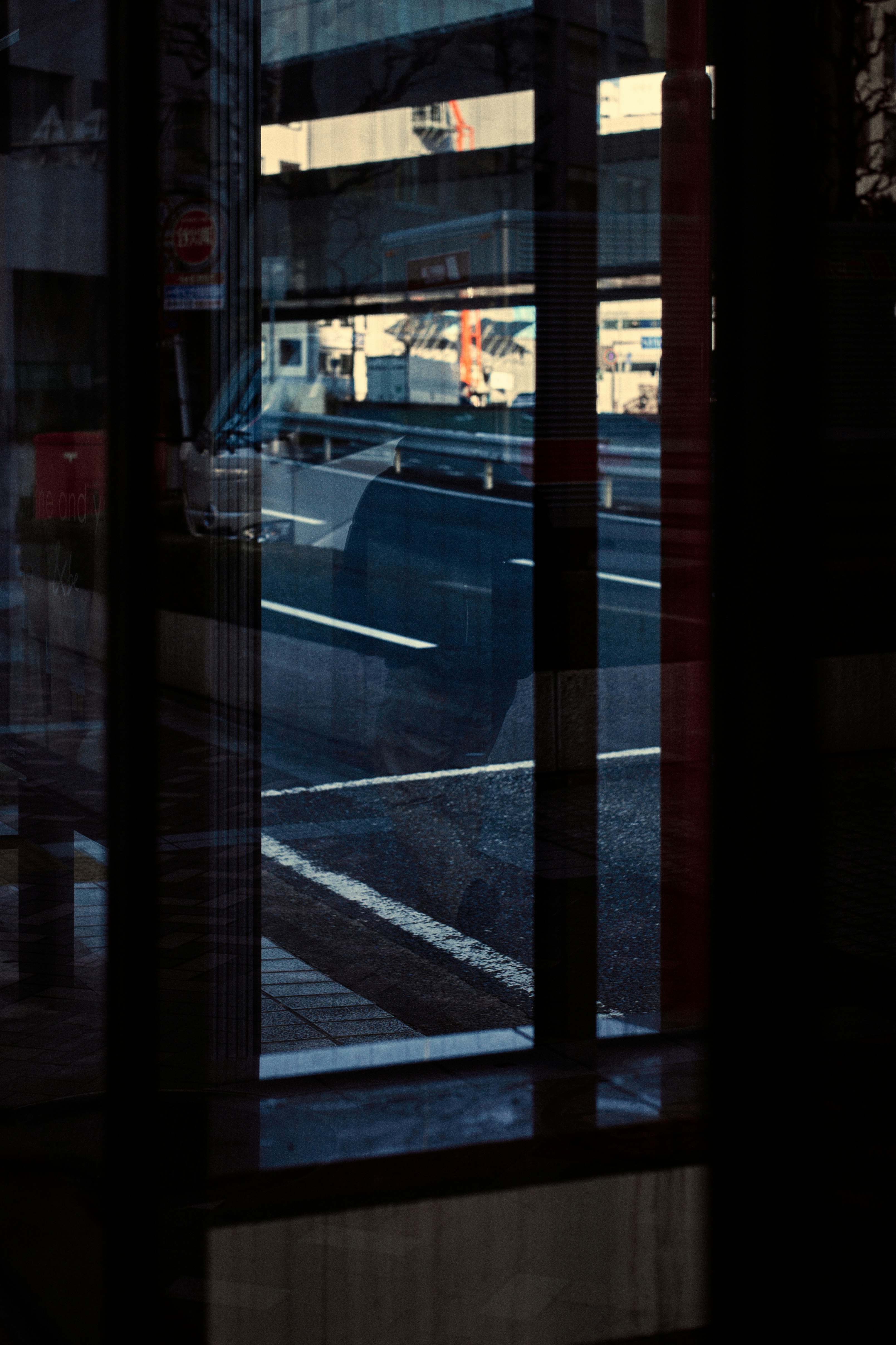Image of a glass window reflecting a road