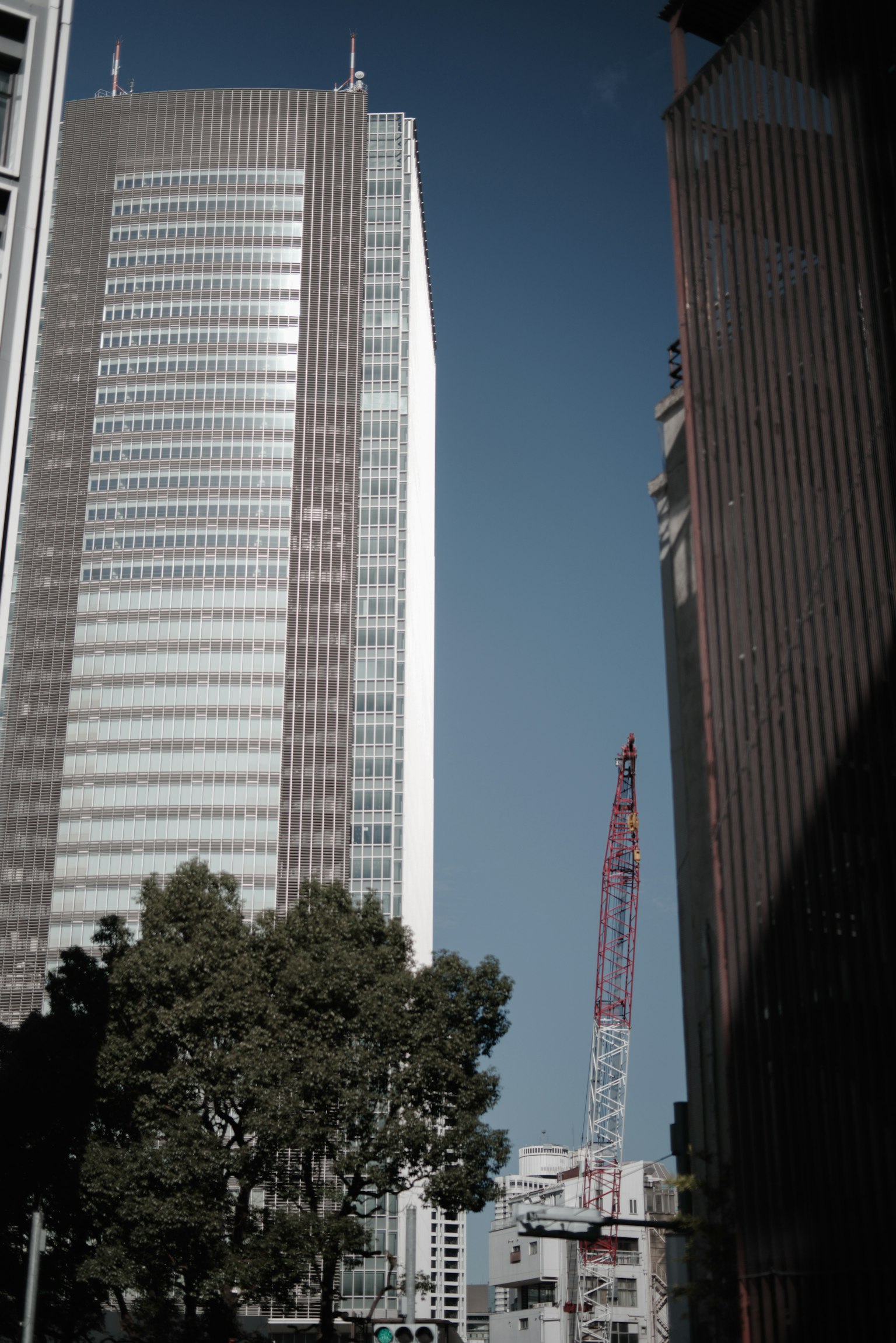 Urban scene featuring skyscrapers and a crane