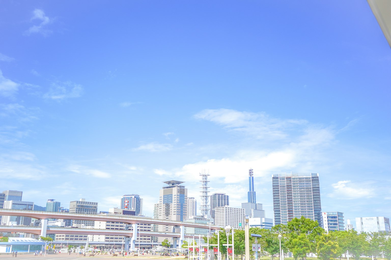 City skyline with high-rise buildings under a clear blue sky