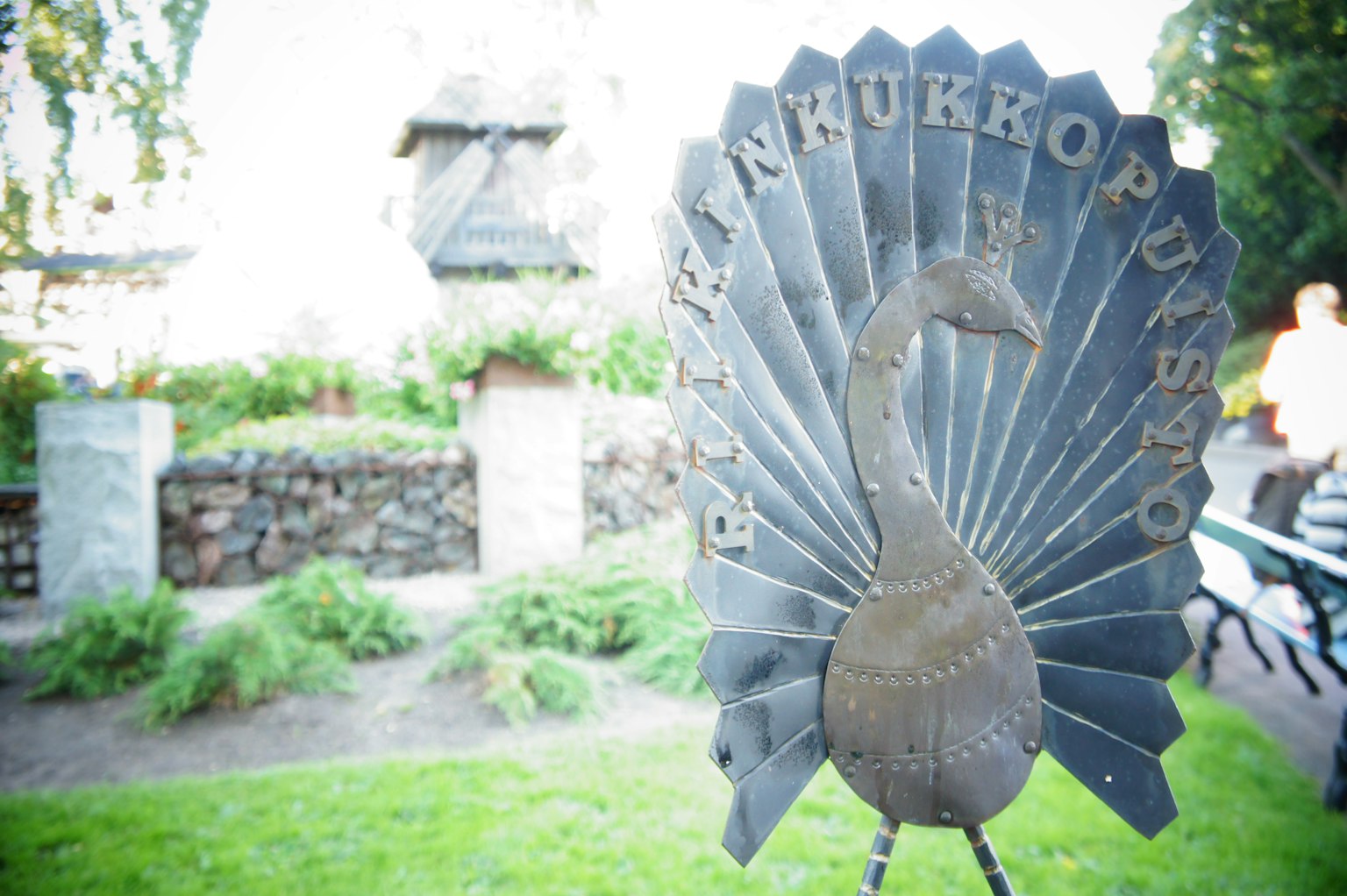 Metal sign featuring a beautiful peacock design