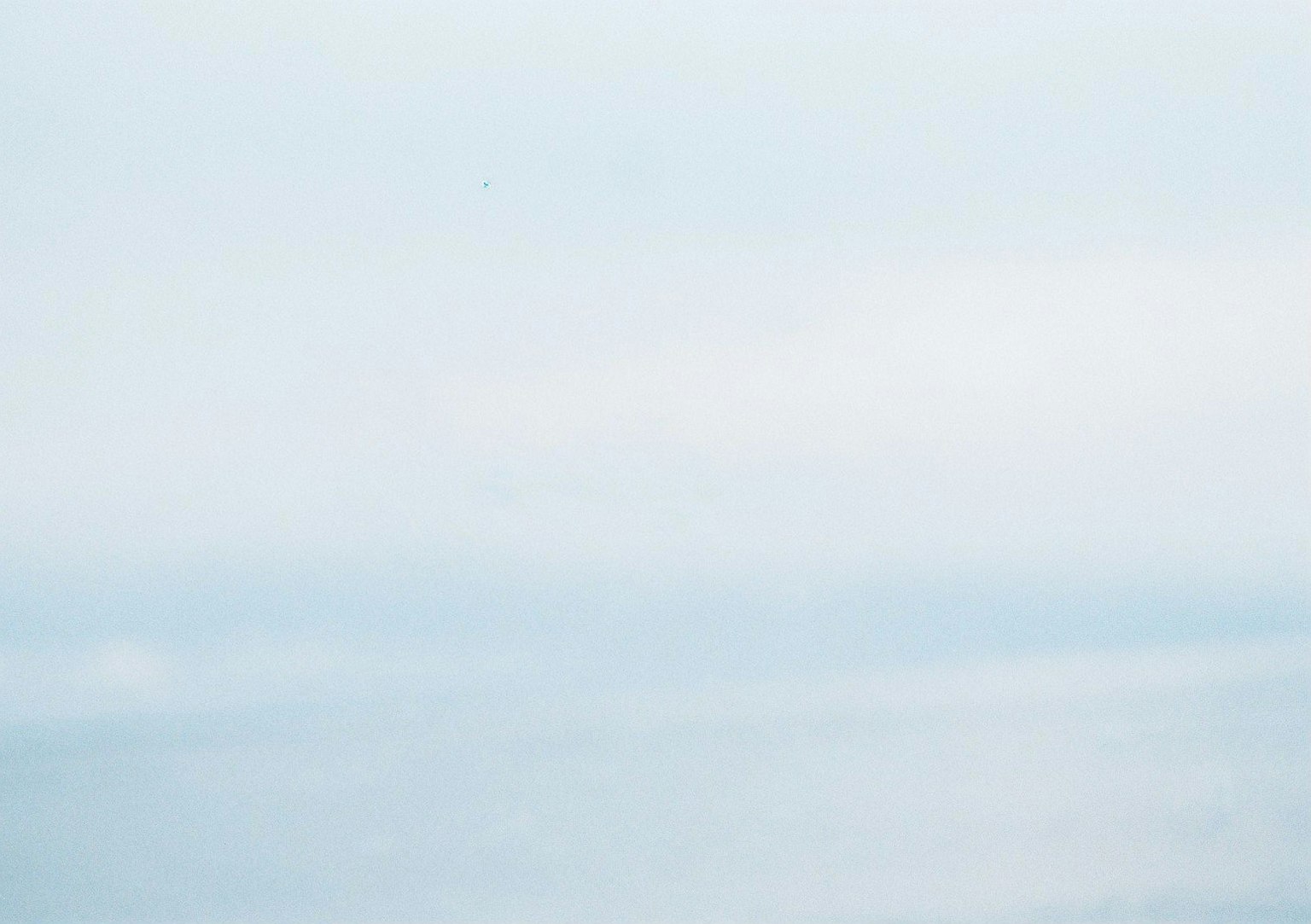 Serene view of a blue sea and soft sky