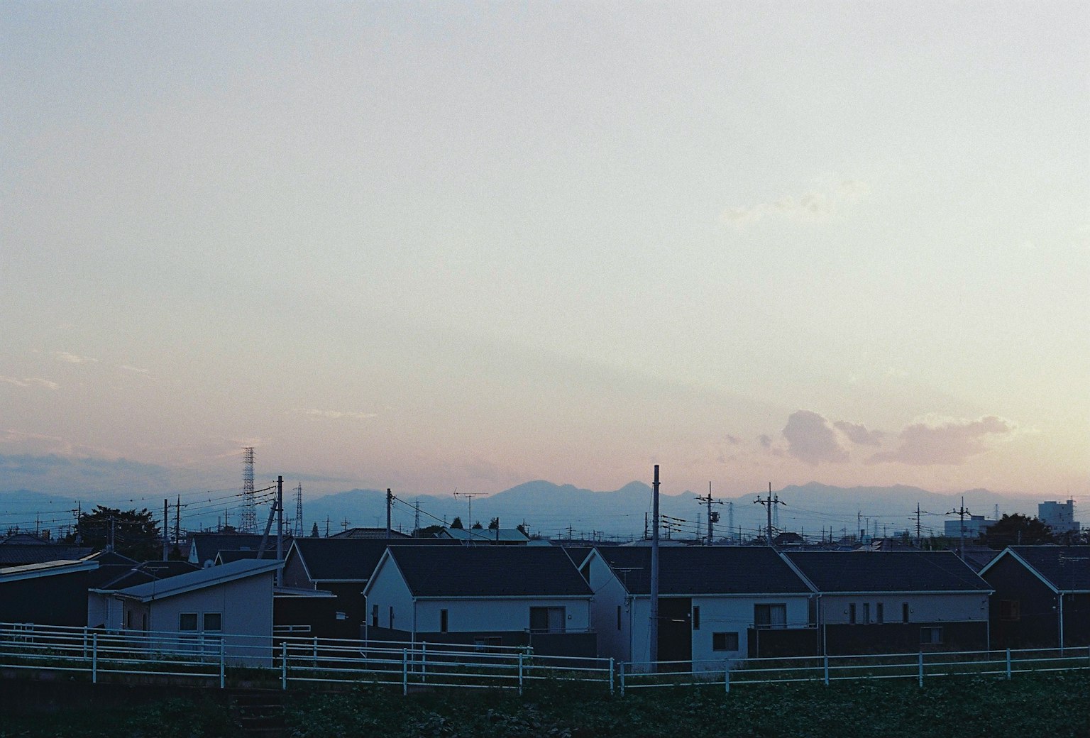 Residential area at dusk with mountains in the background