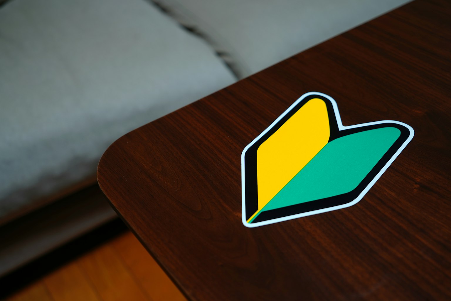 Autocollant en forme de cœur vert et jaune sur une table en bois