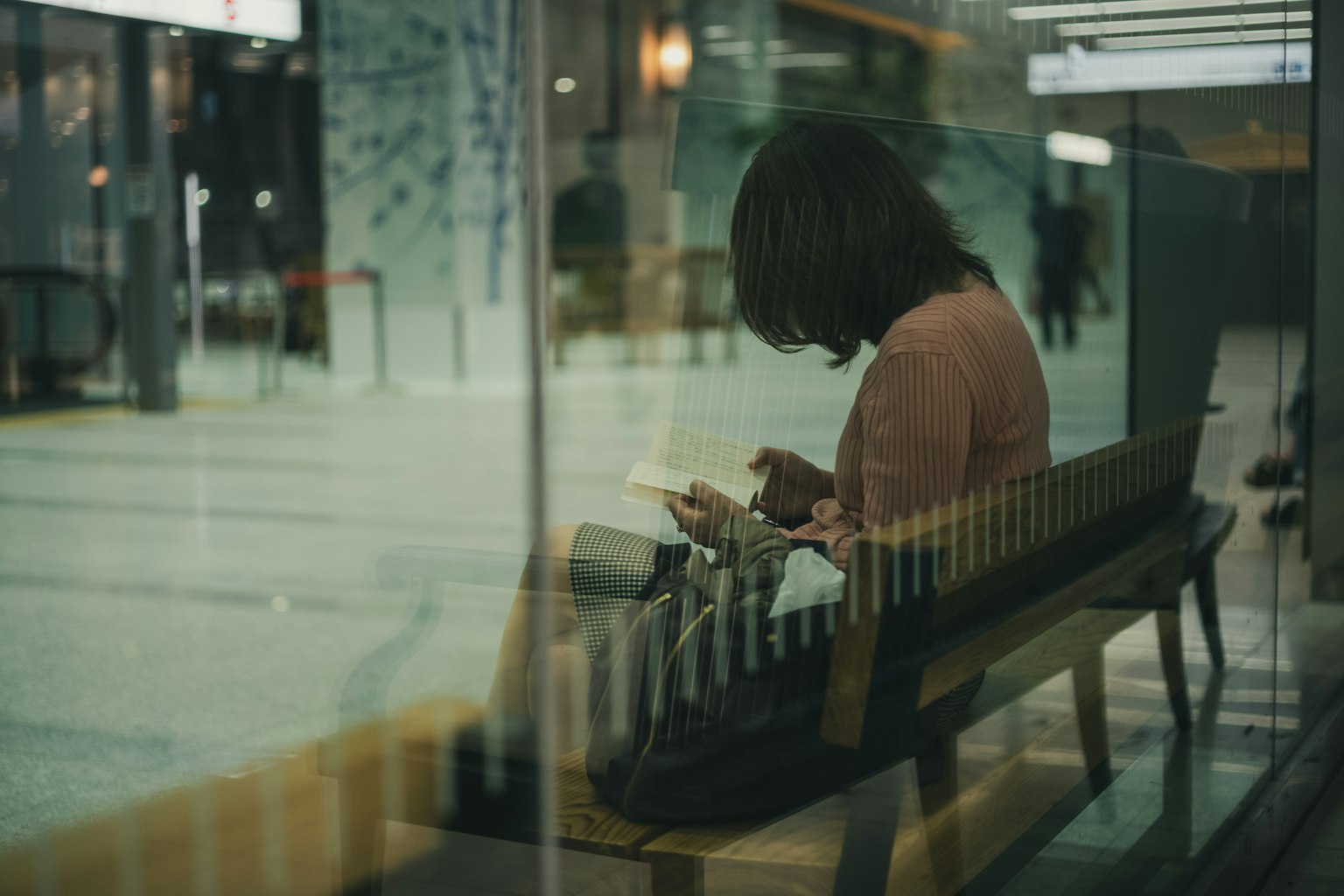 女人坐在长椅上看手机