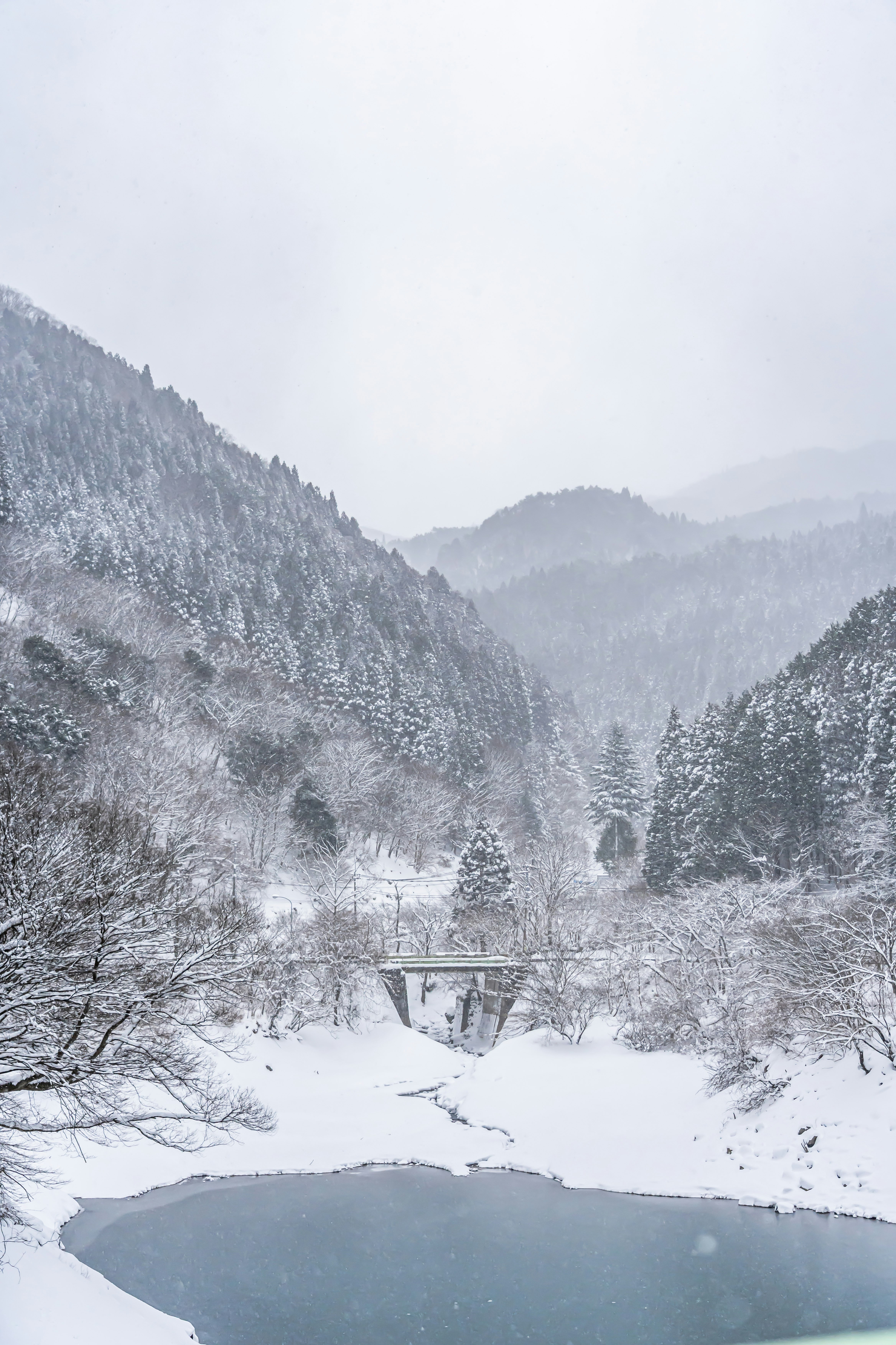 Snow-covered mountains and a tranquil river landscape