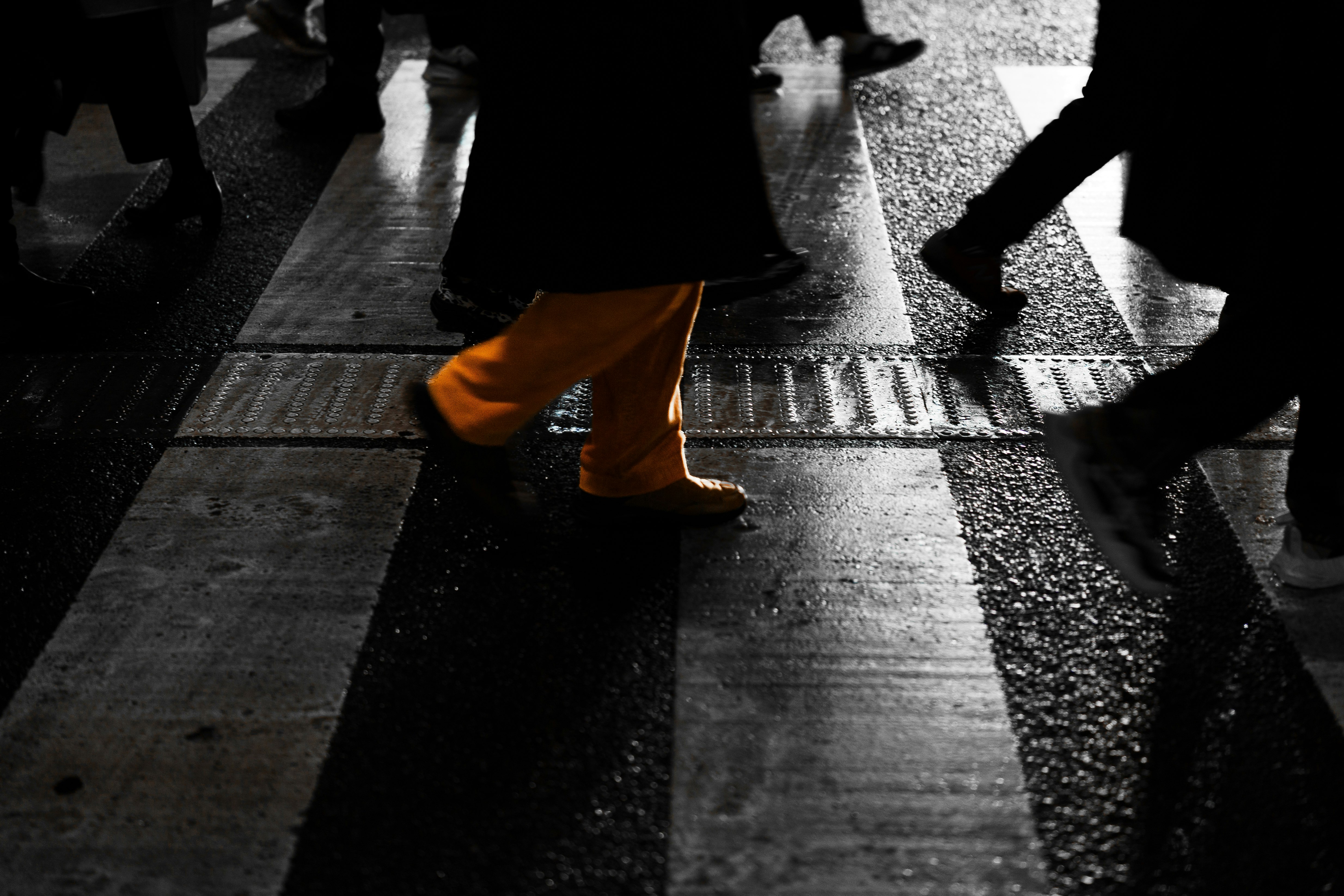 people walking on a rain-slick street