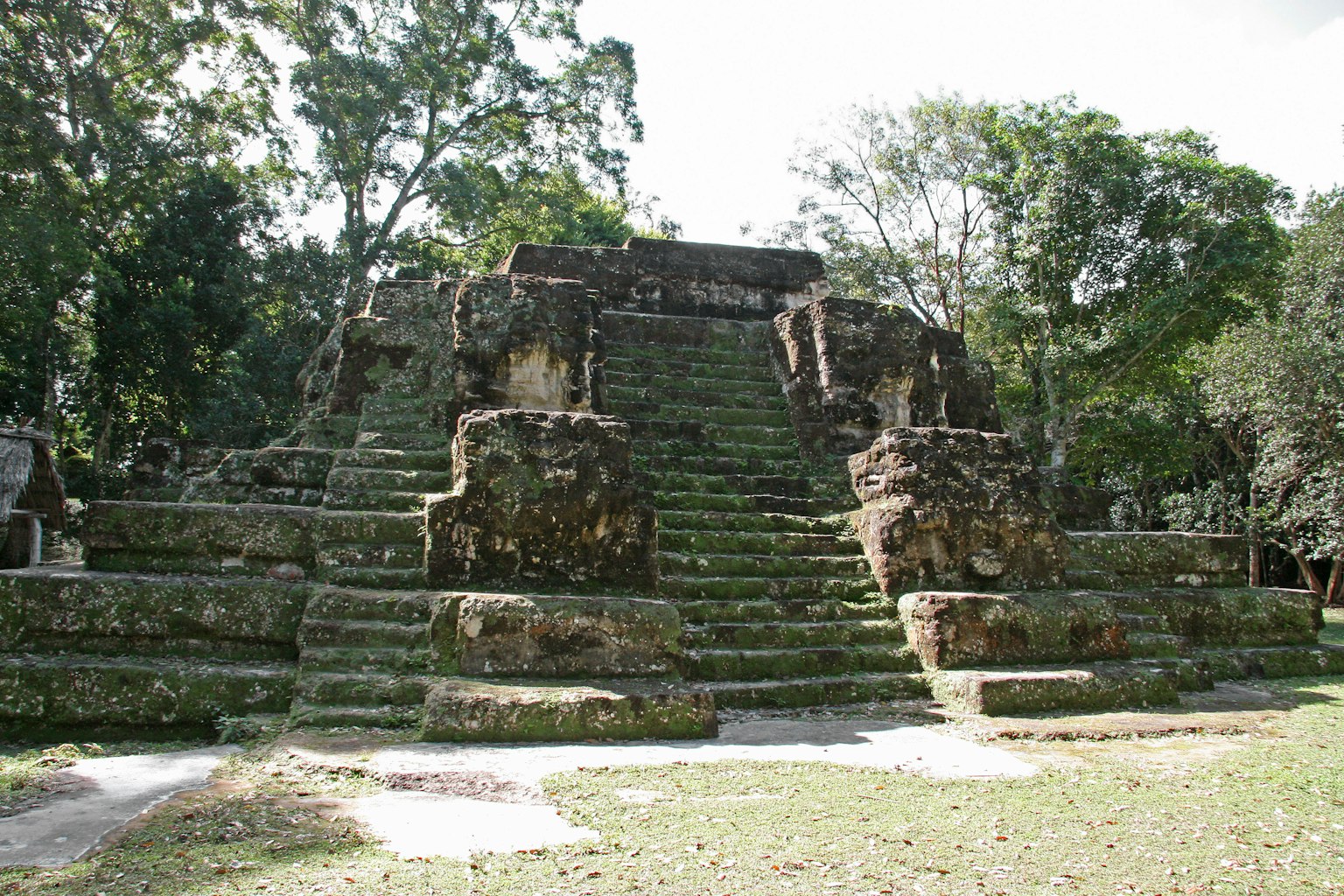 Ancient stone temple with moss-covered steps and lush greenery