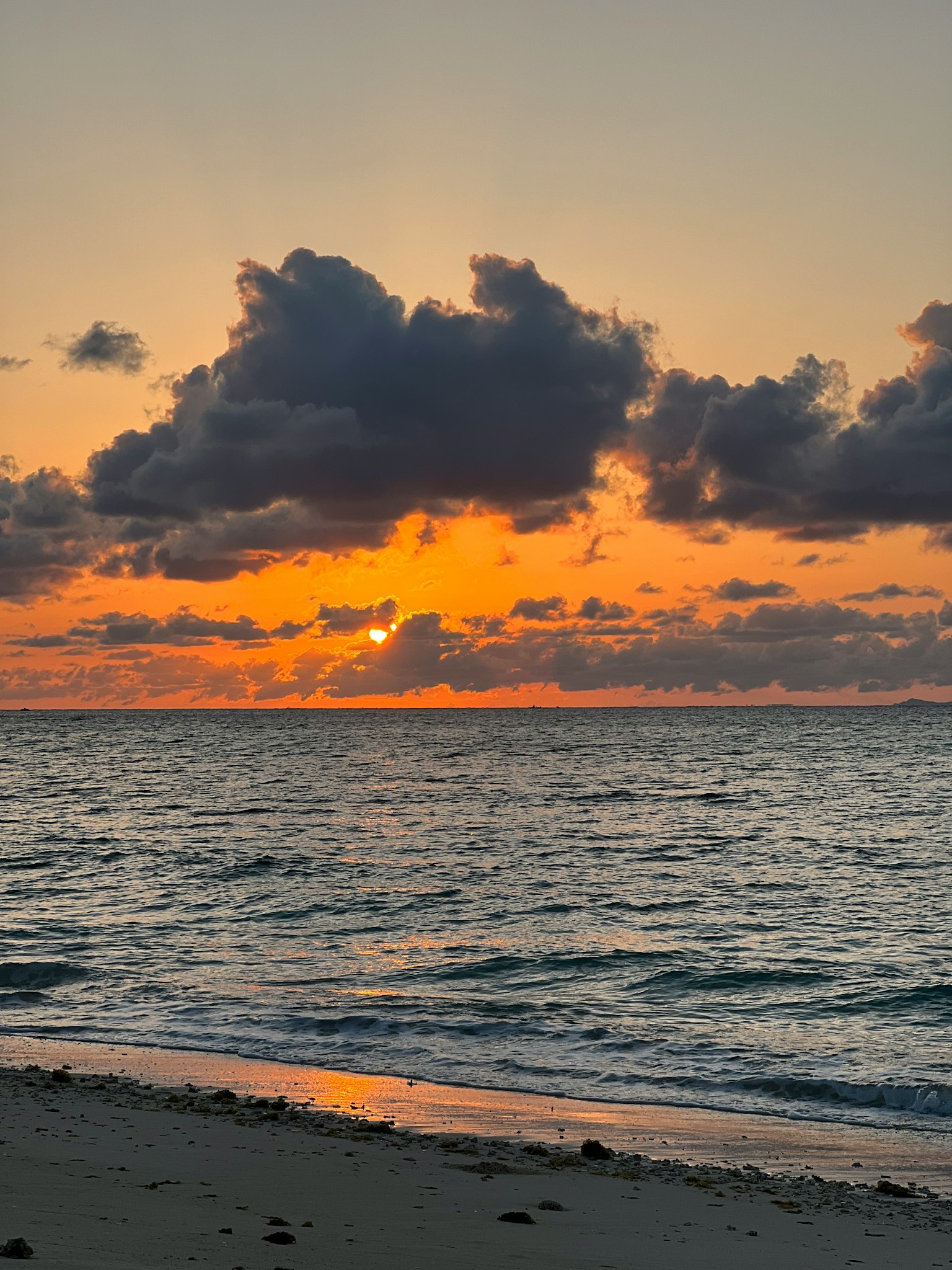 Sunset over the ocean with clouds in the sky