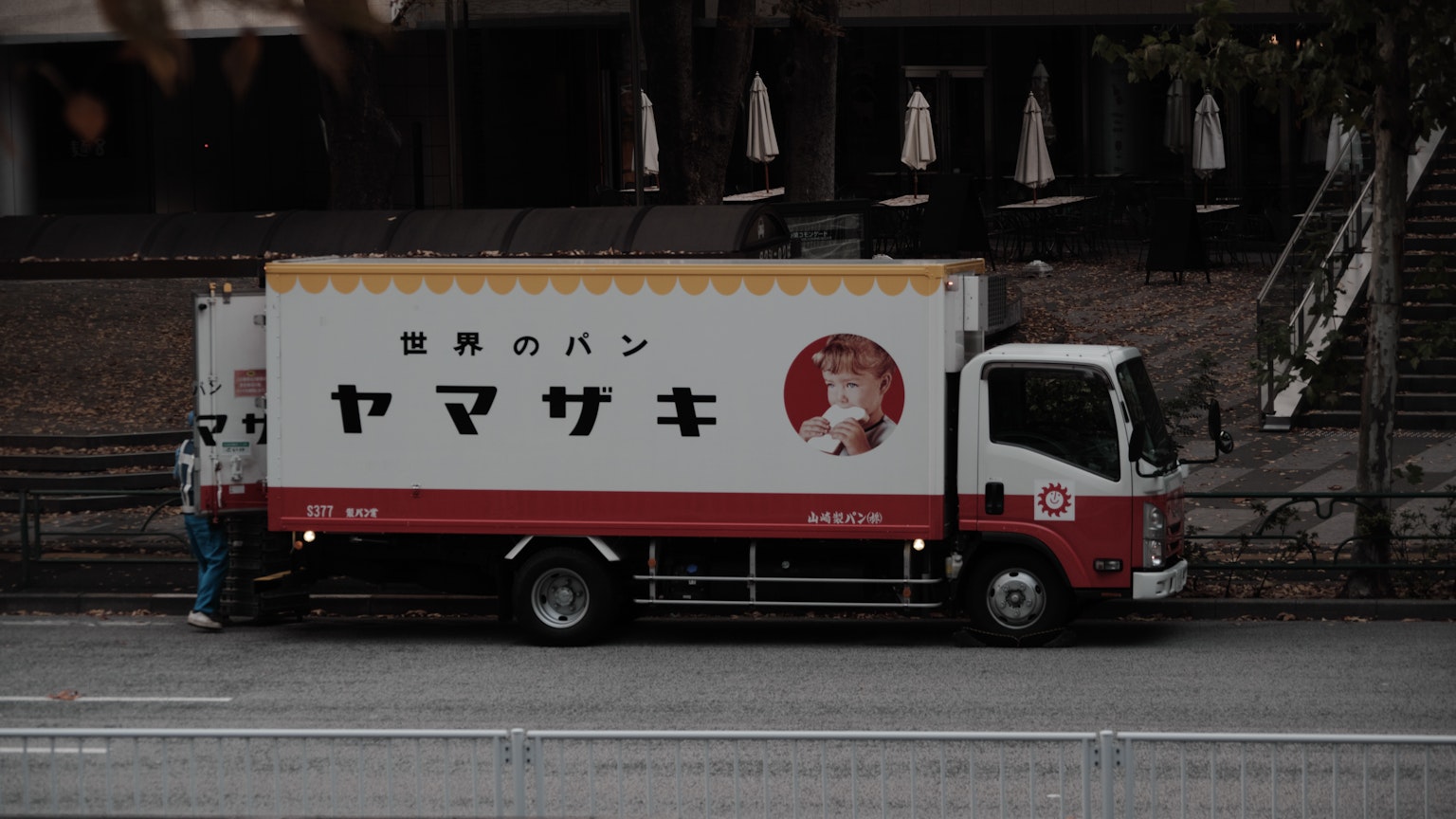 A truck carrying Yamazaki bread parked in an urban setting