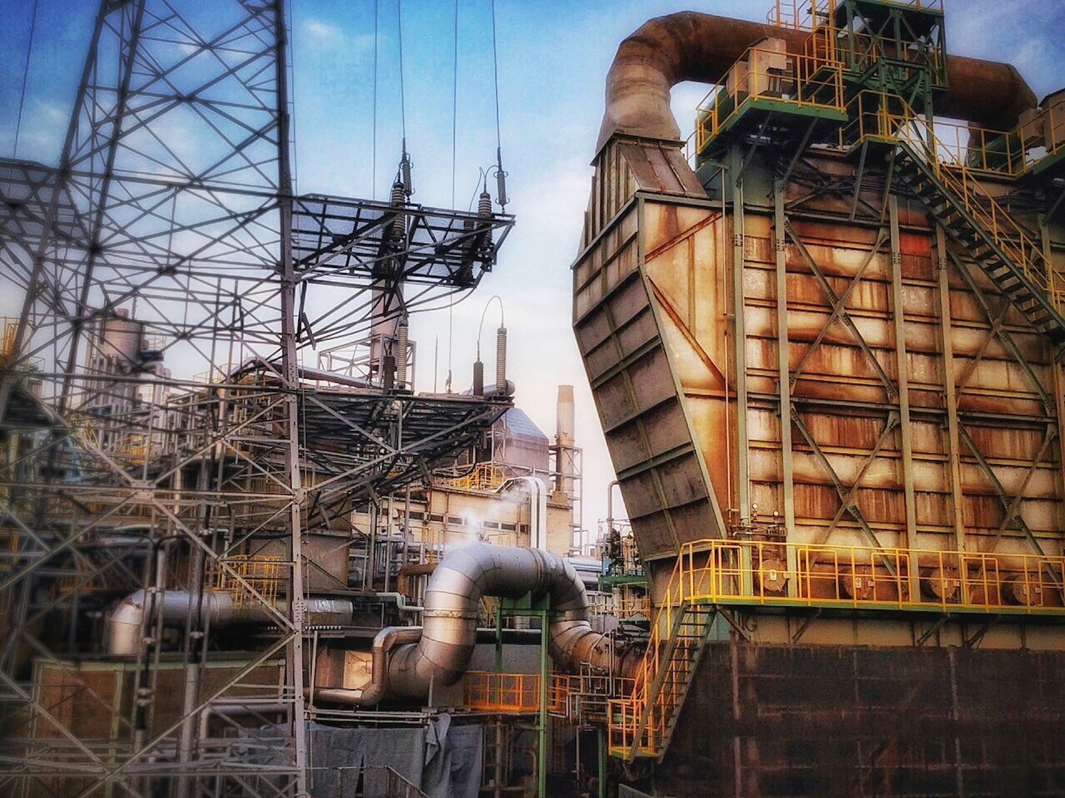 Industrial landscape featuring complex structures and pipes