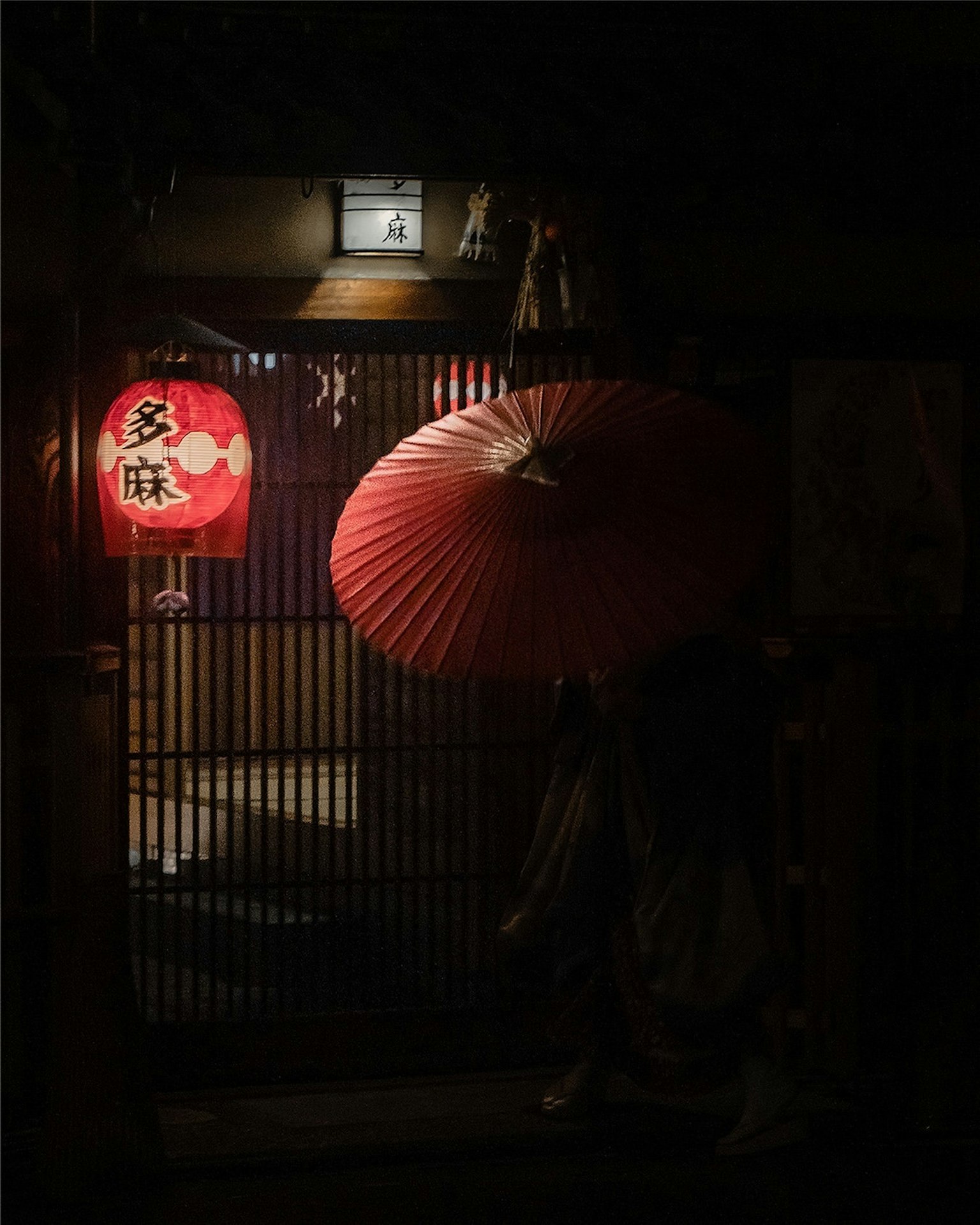 Japanese night scene with red lantern and traditional umbrella