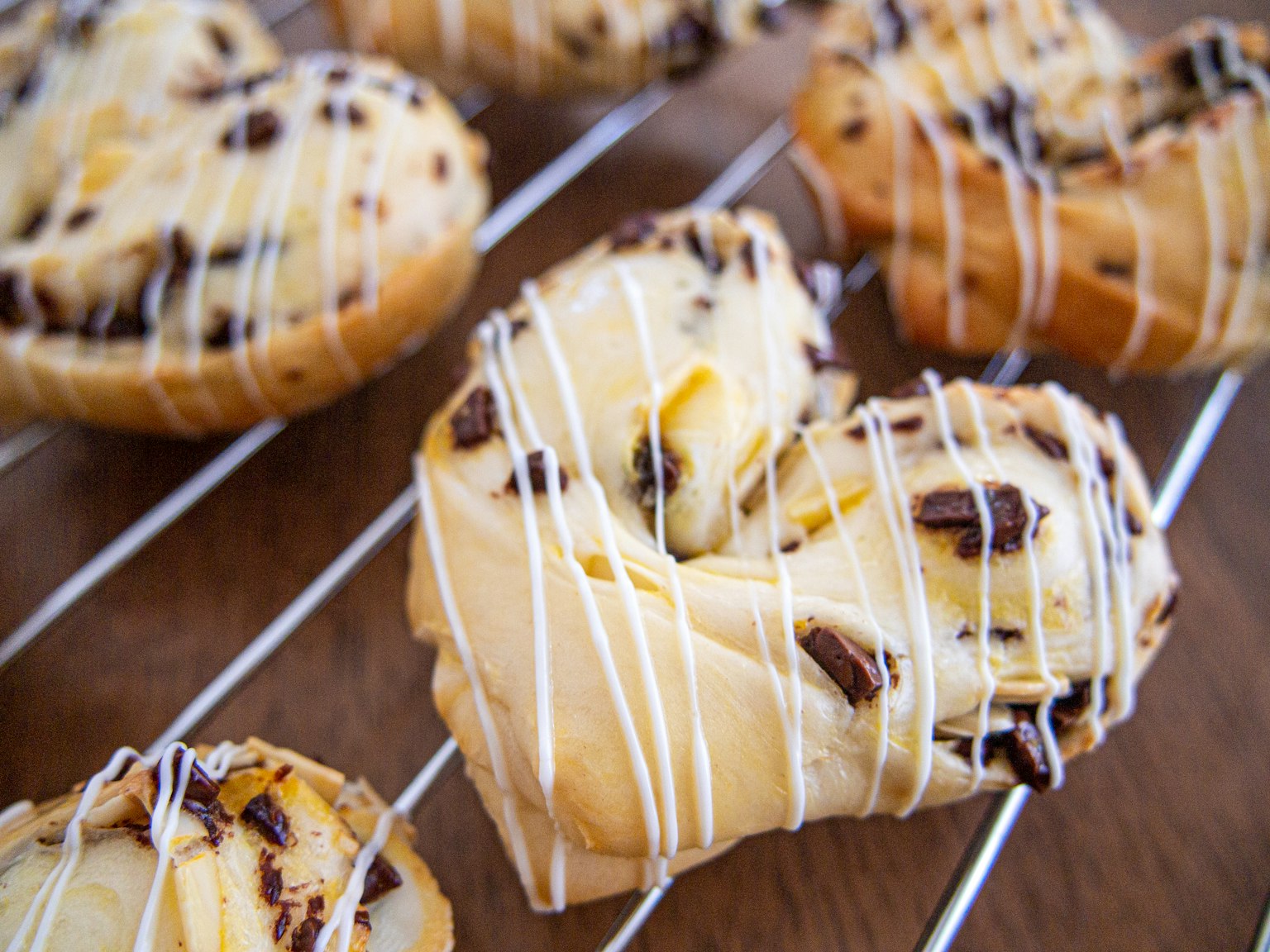 Heart-shaped chocolate Danish pastries drizzled with white icing