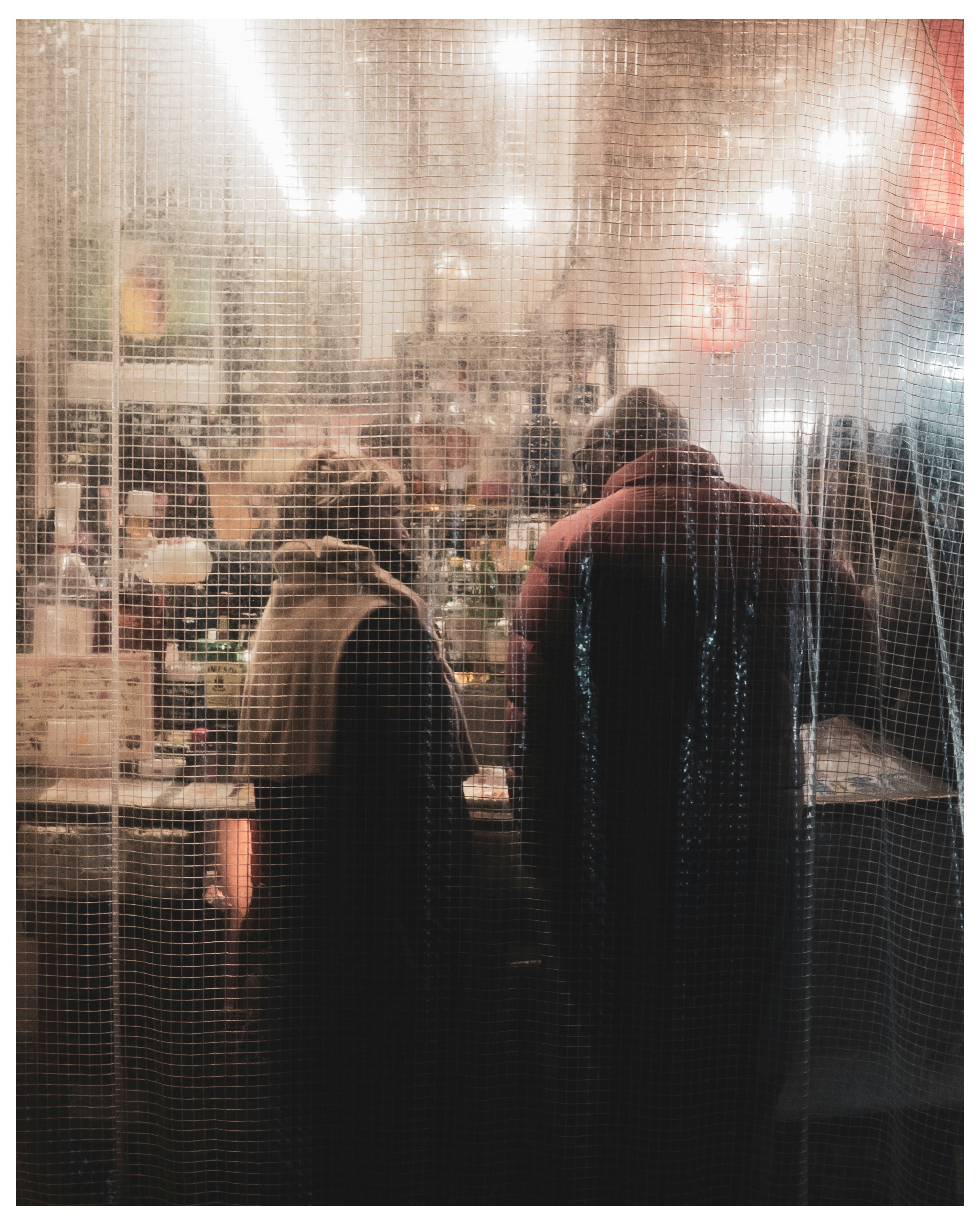 Office space with people seen through glass and city lights layered