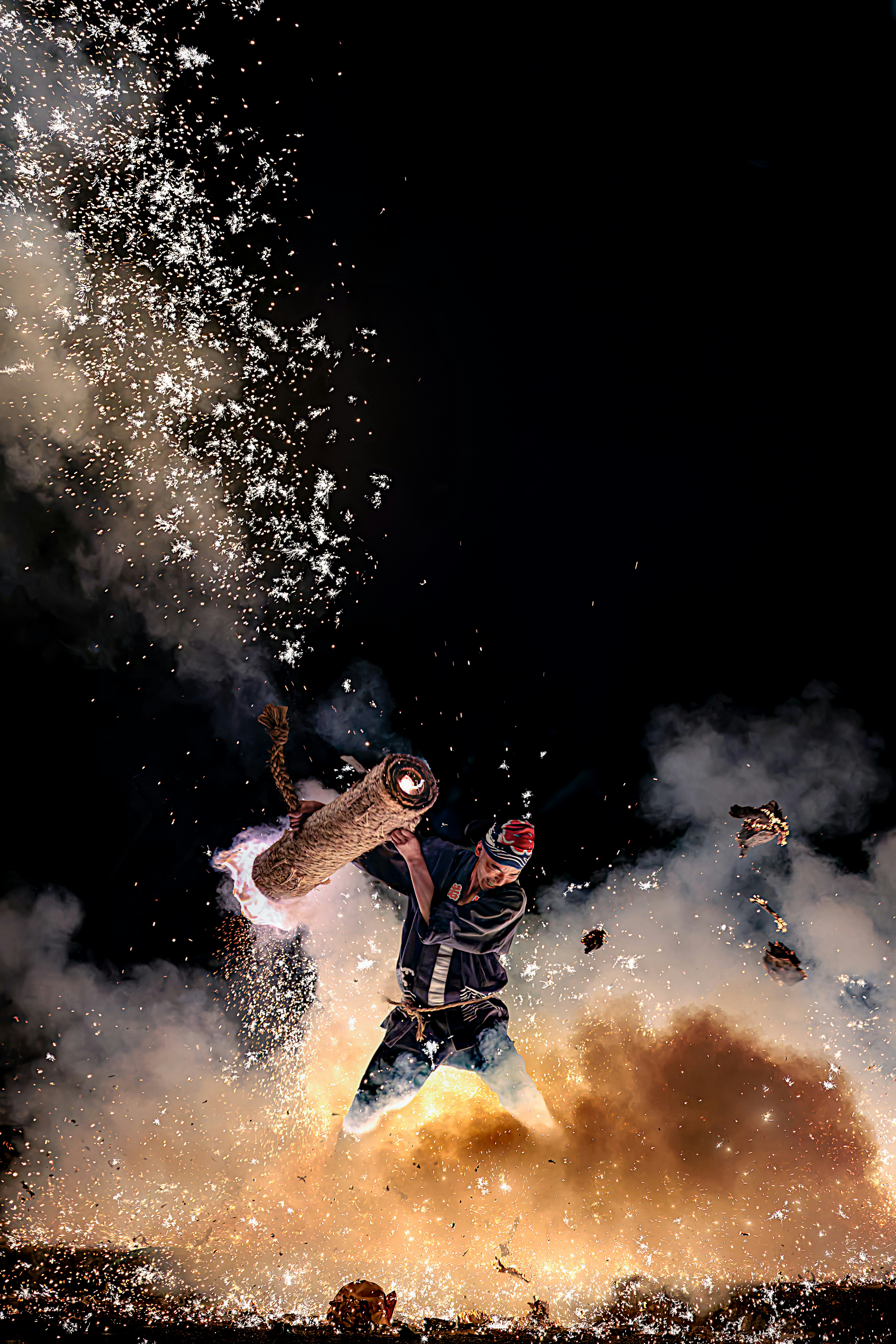 dog-like animal jumping through flames and dust