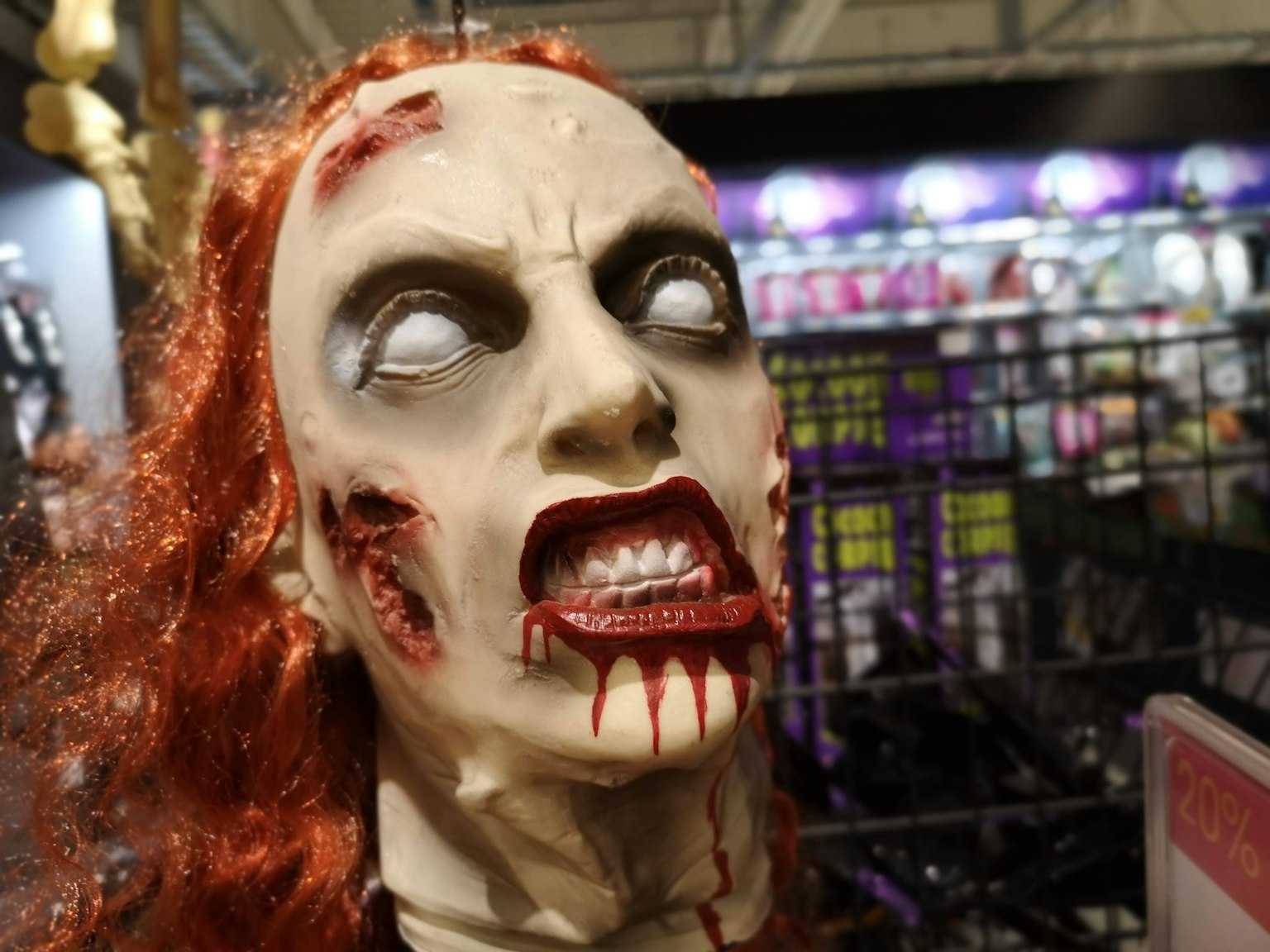 Búp bê zombie với khuôn mặt đầy máu và tóc đỏ, mắt trắng