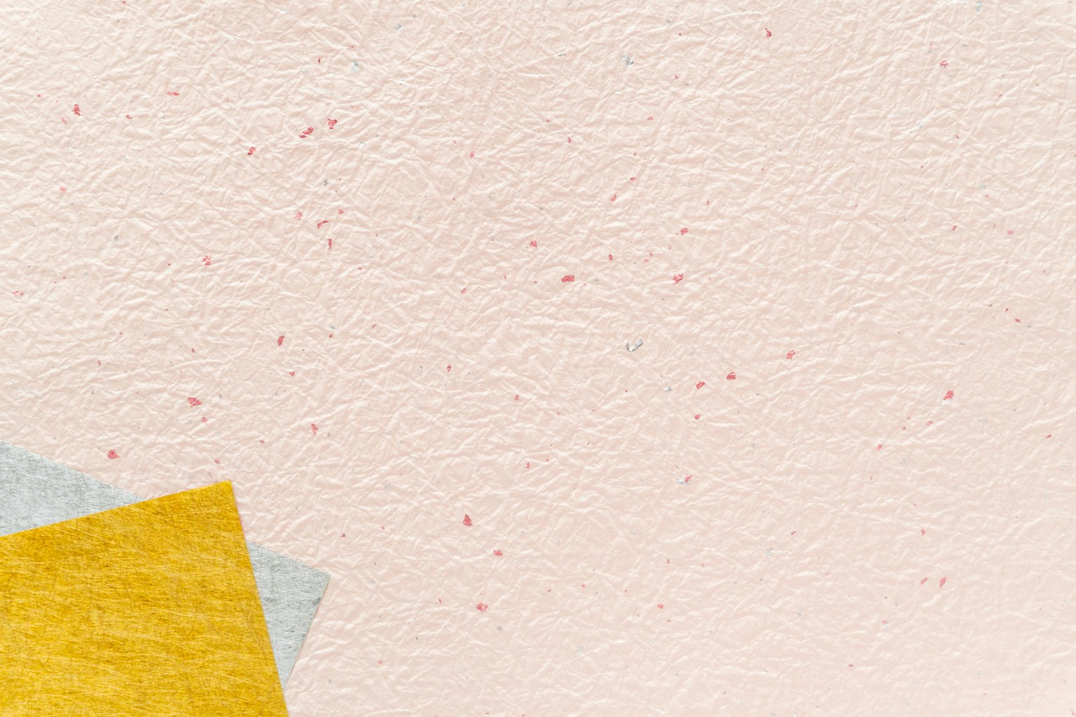 Light pink background with yellow and blue paper pieces