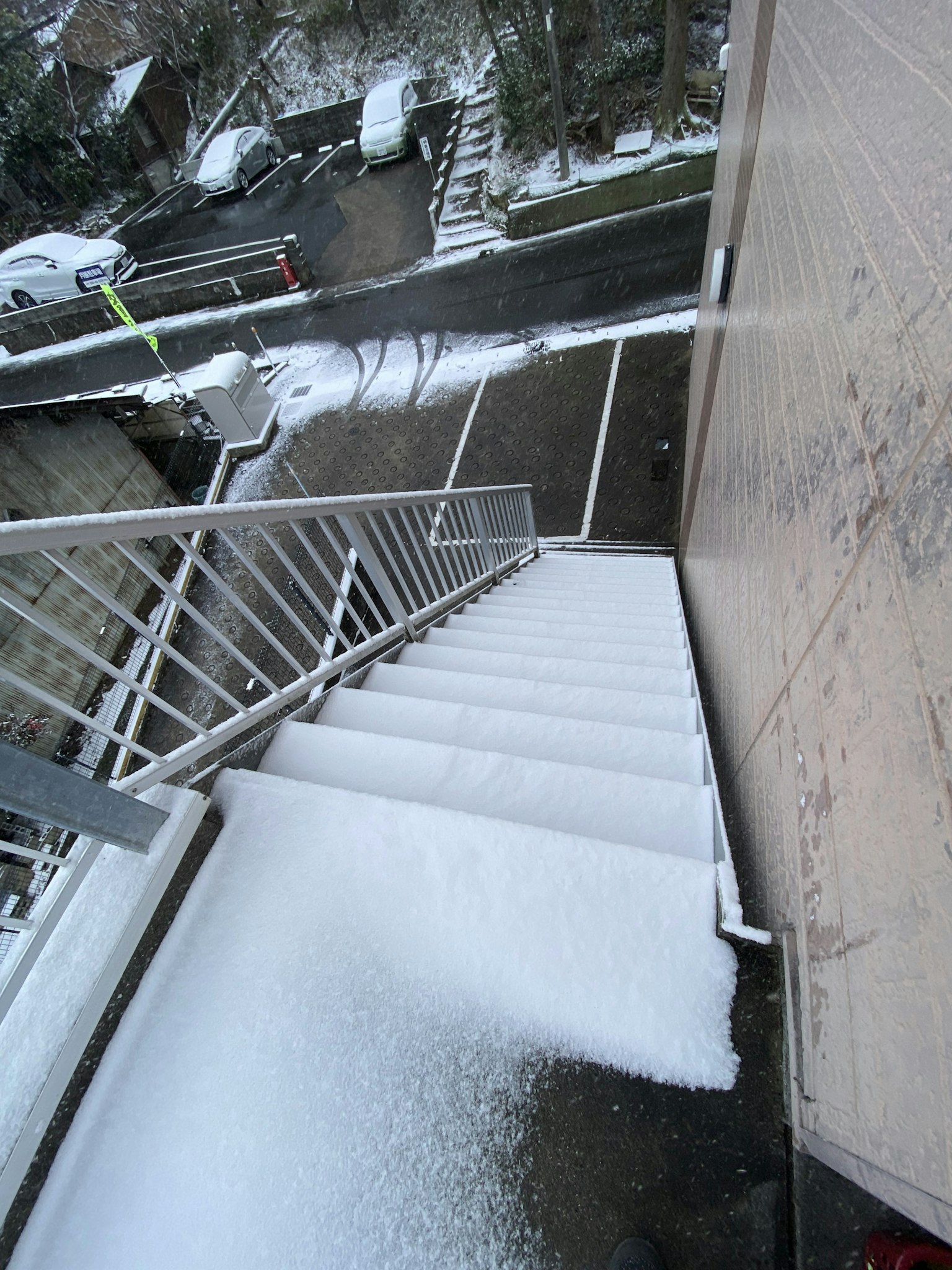Image of snow-covered stairs with a layer of white snow visible on the steps