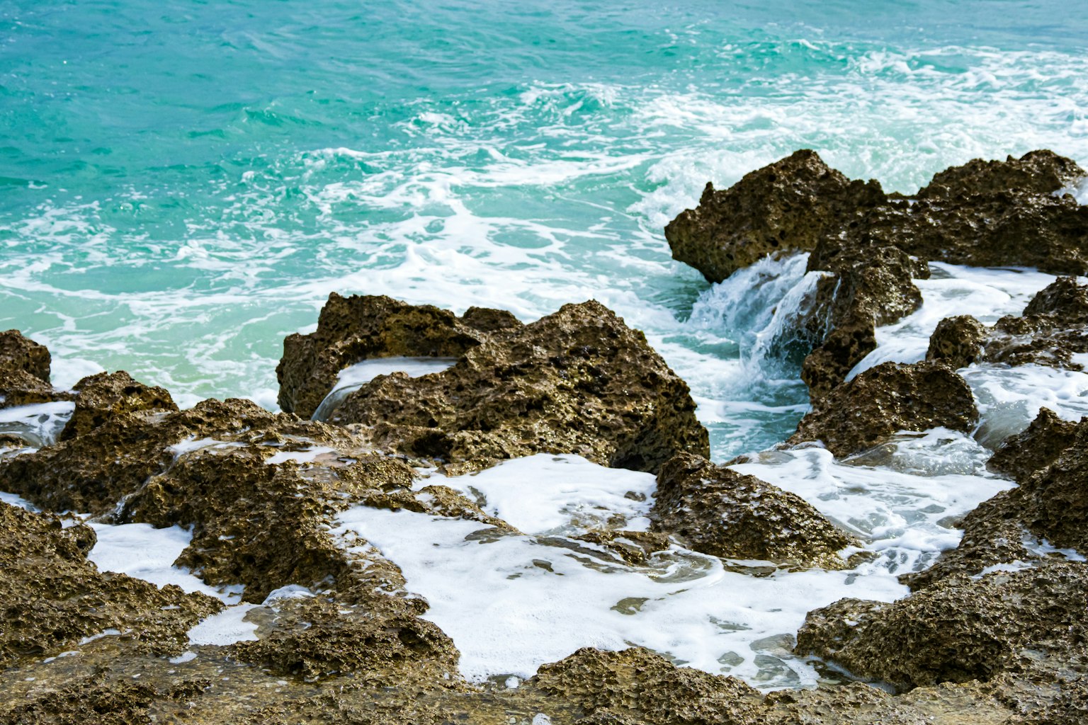Coastal scene with blue ocean waves and rocky shoreline
