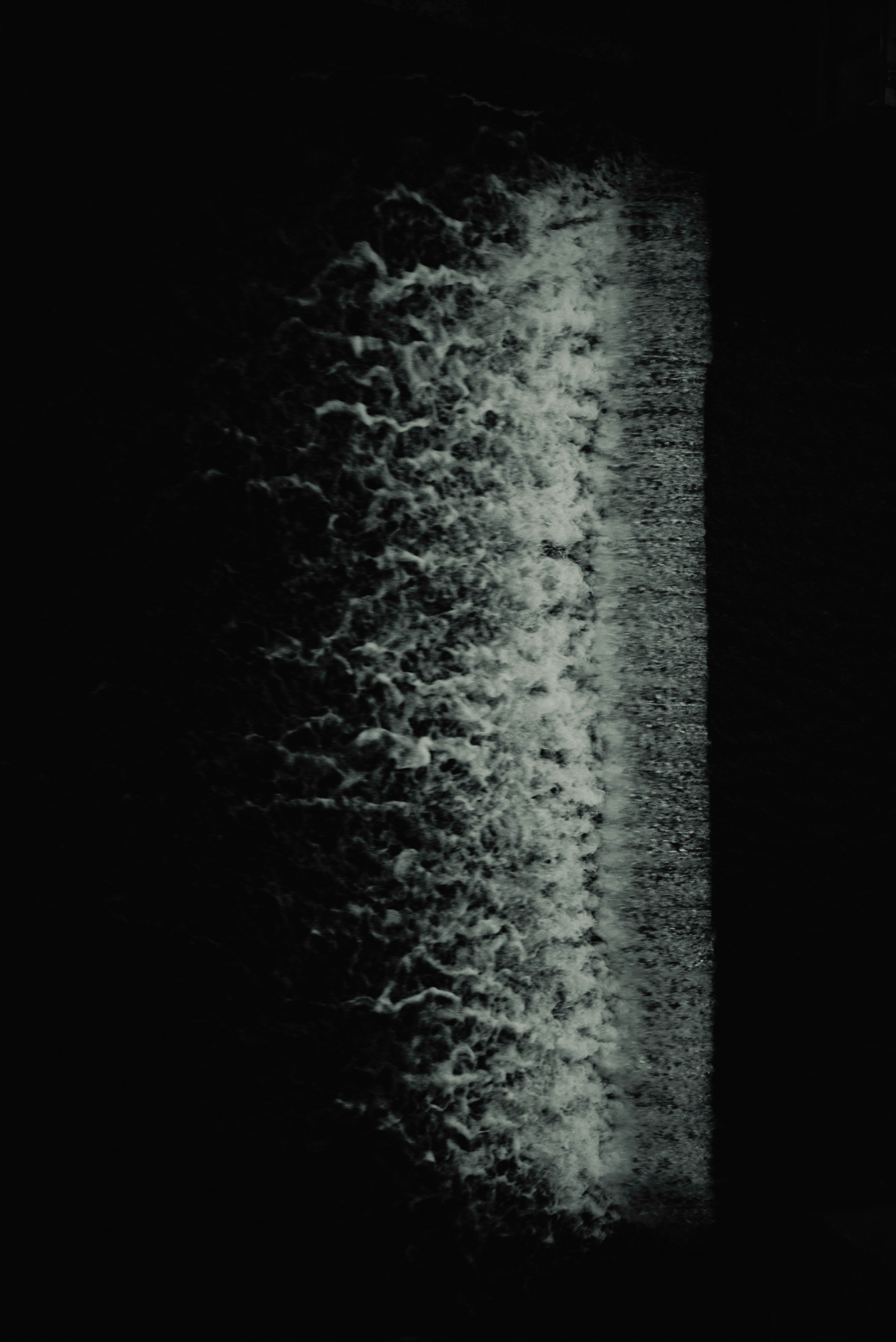 white text-like texture traces on a dark background