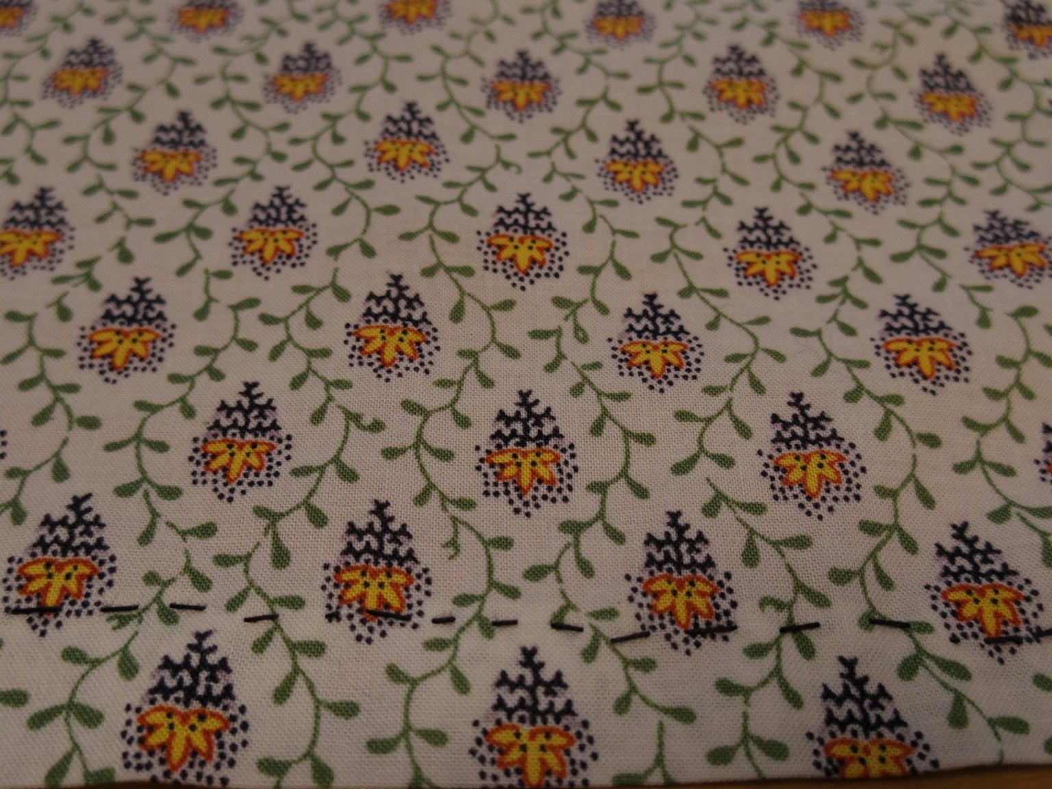 Fabric pattern featuring yellow and purple floral design