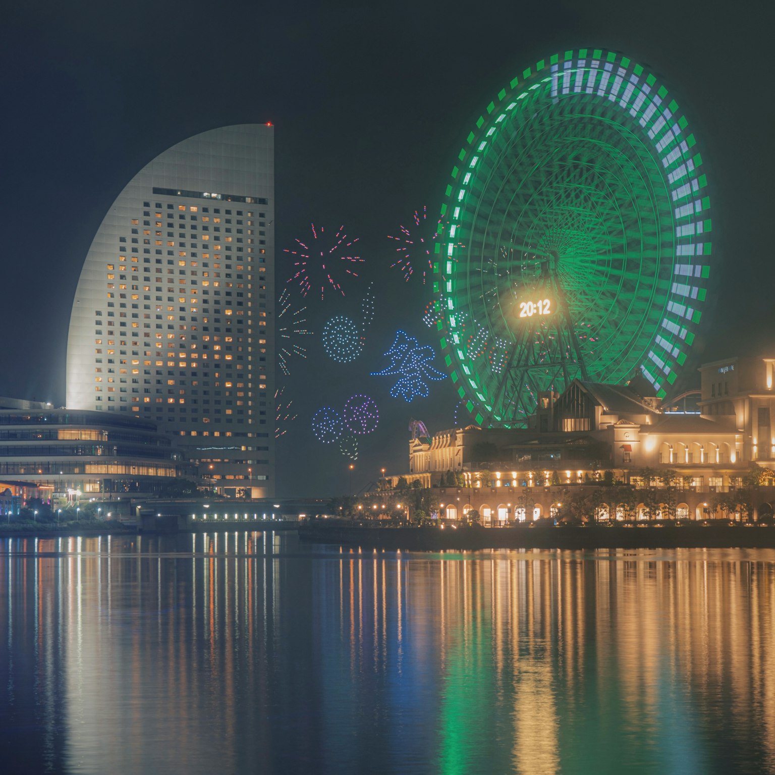 Beautiful night view of Yokohama featuring fireworks and a ferris wheel