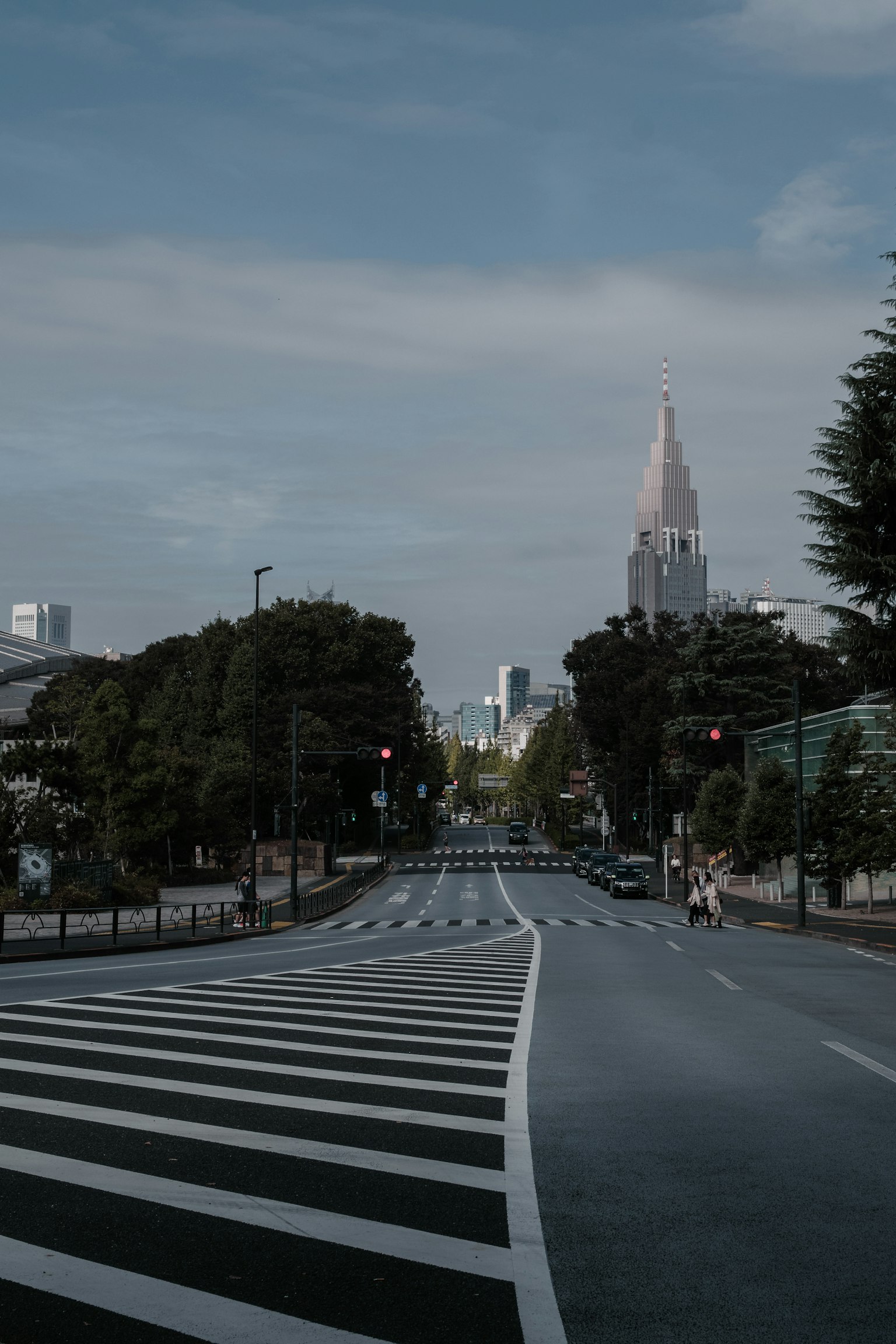 Quiet street with striped crosswalks and distant tower