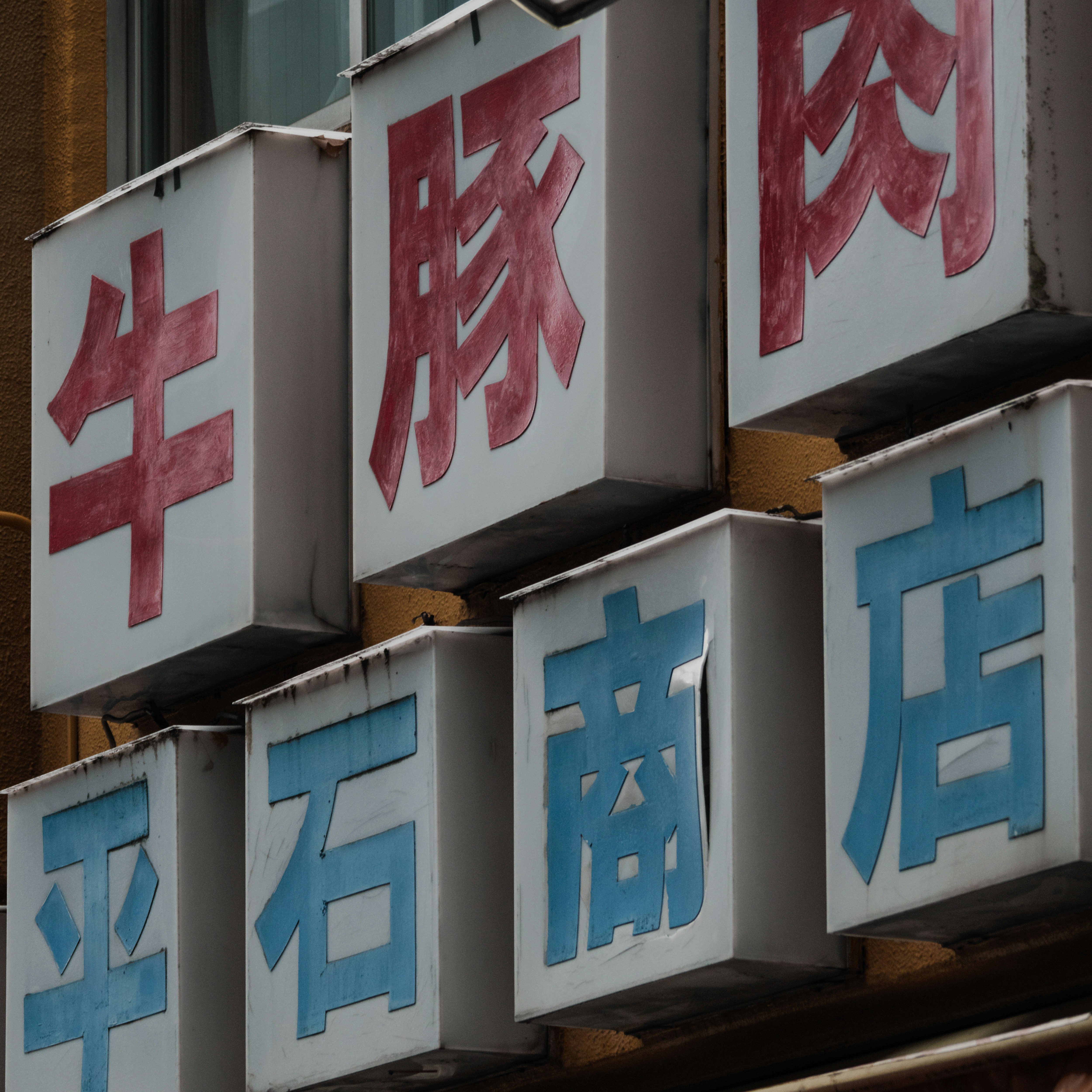 Dãy cửa hàng ở Tokyo trong con hẻm với biển hiệu thịt và tiệm thịt
