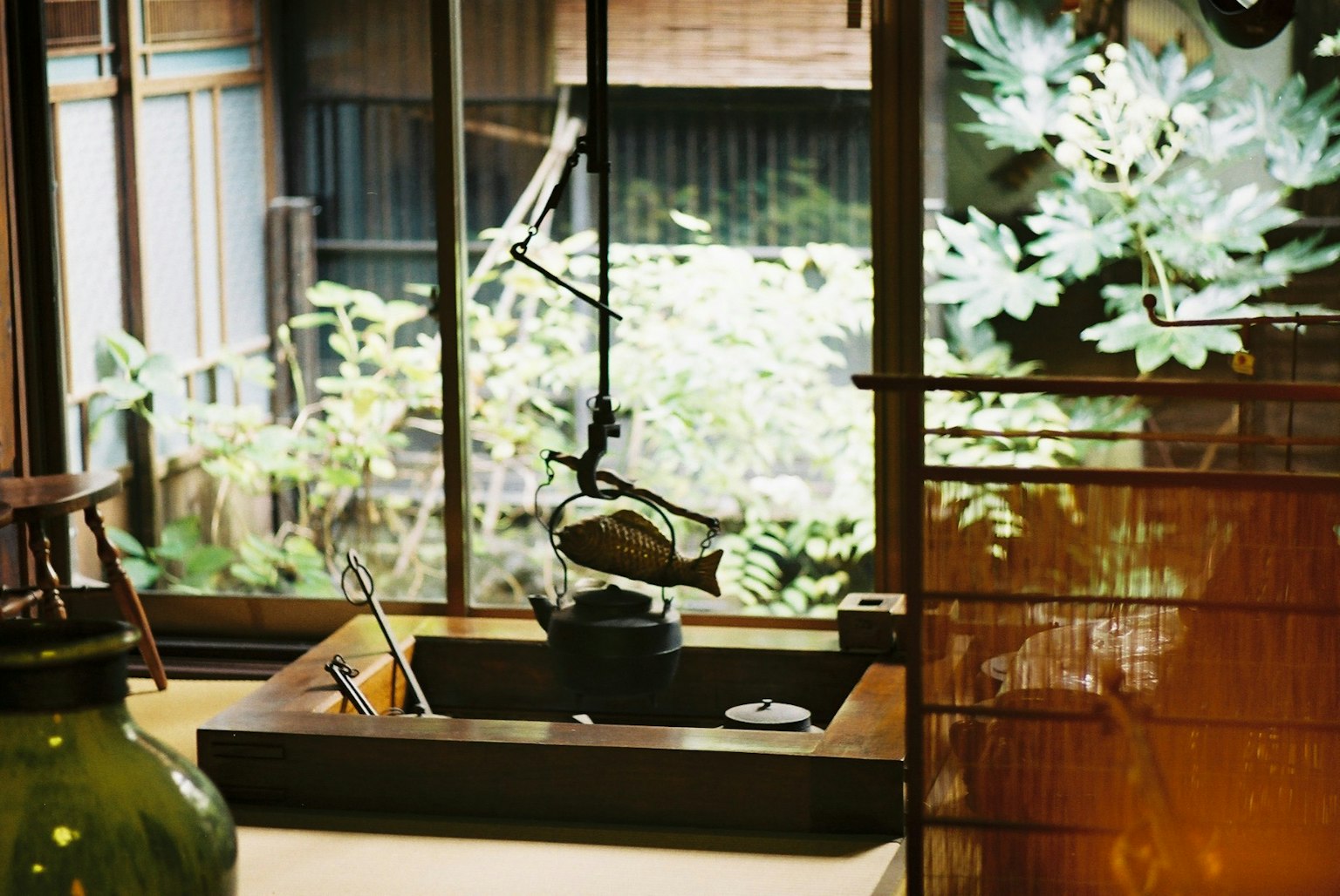 Serene Japanese interior featuring a water feature and green plants visible