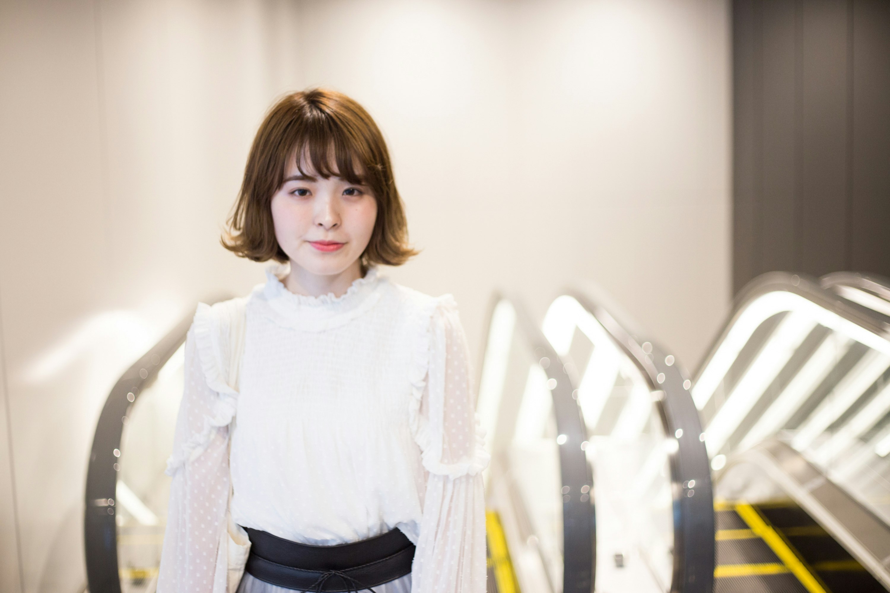 白いブラウスの女性と鏡の前の室内スタイリング