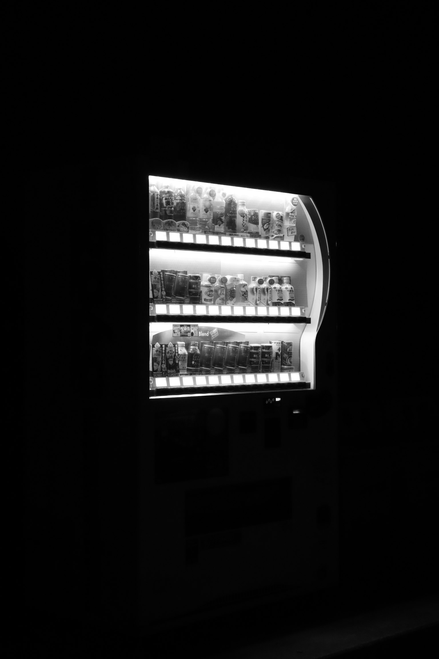 A brightly lit vending machine against a dark background