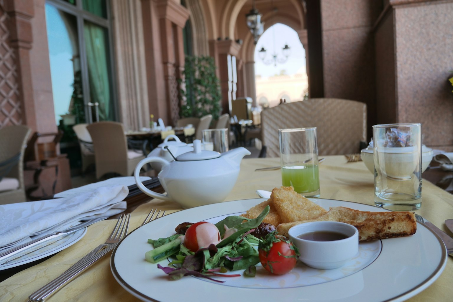 Elegant outdoor dining setup with a colorful salad and gourmet dish