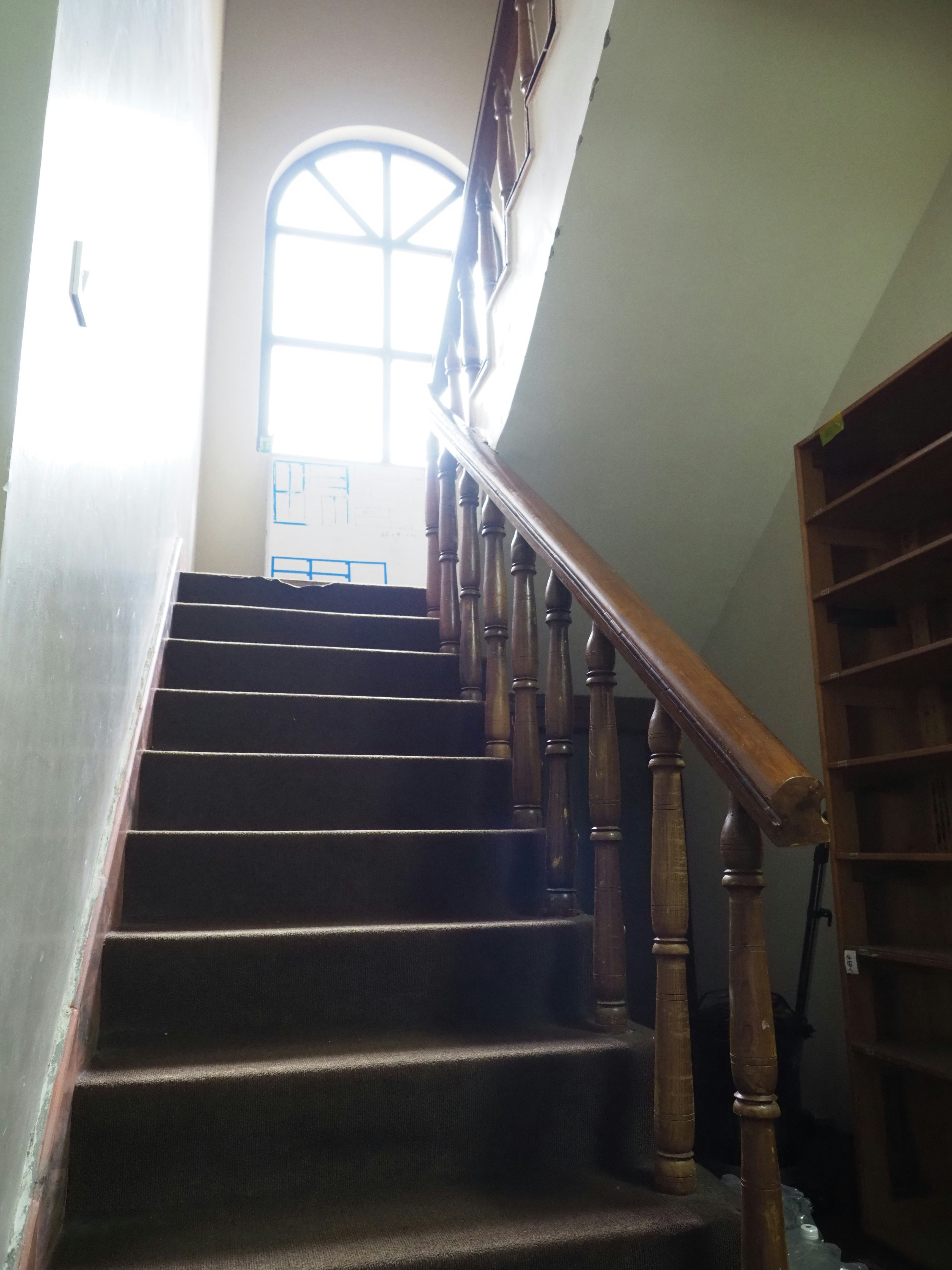 Indoor hallway with staircase and railing