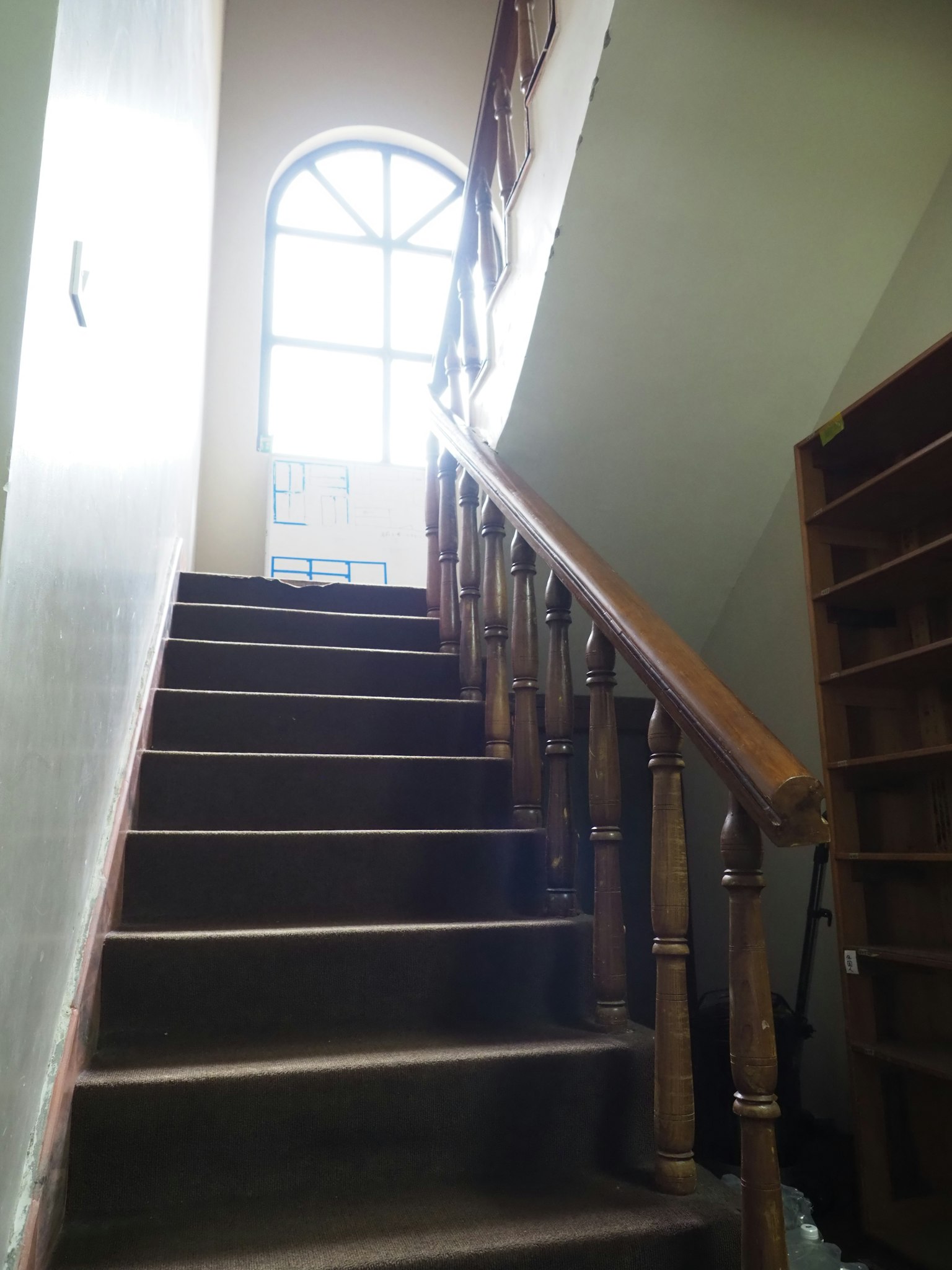 Interior view of a staircase leading to a large window
