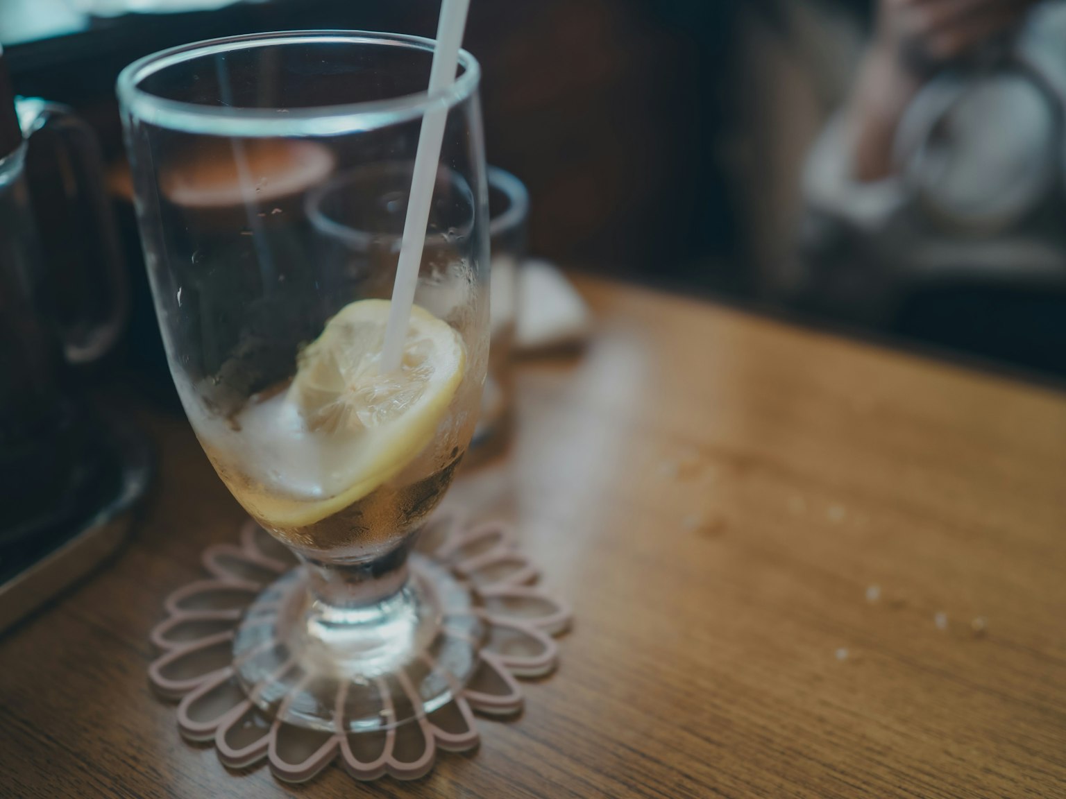 Verre de boisson avec une tranche de citron sur une table en bois