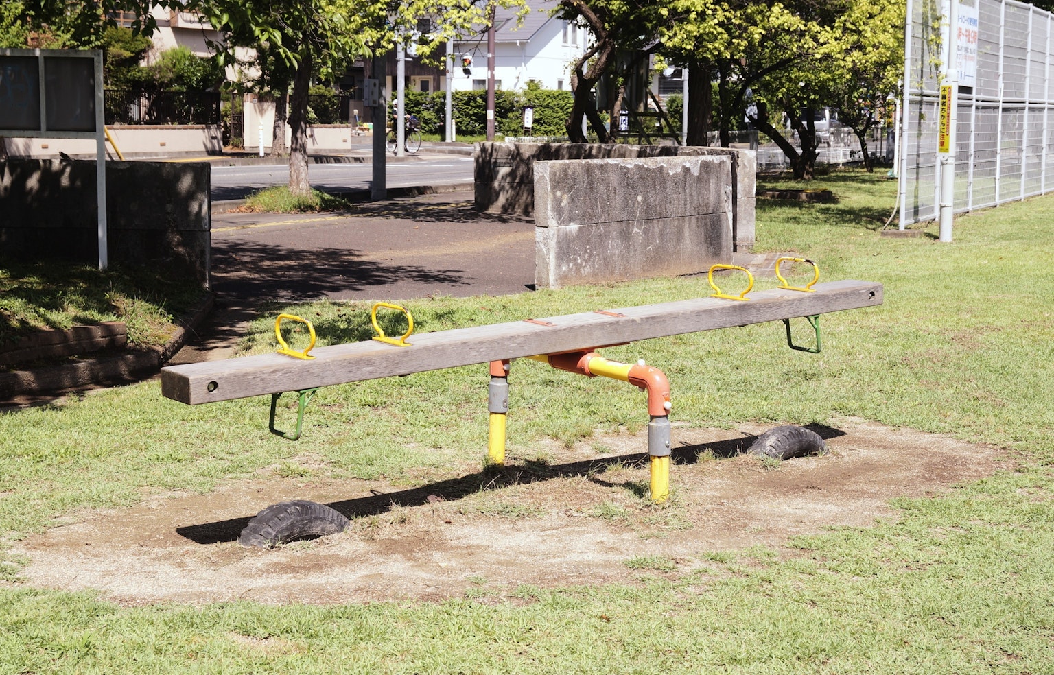 A seesaw on green grass in a park