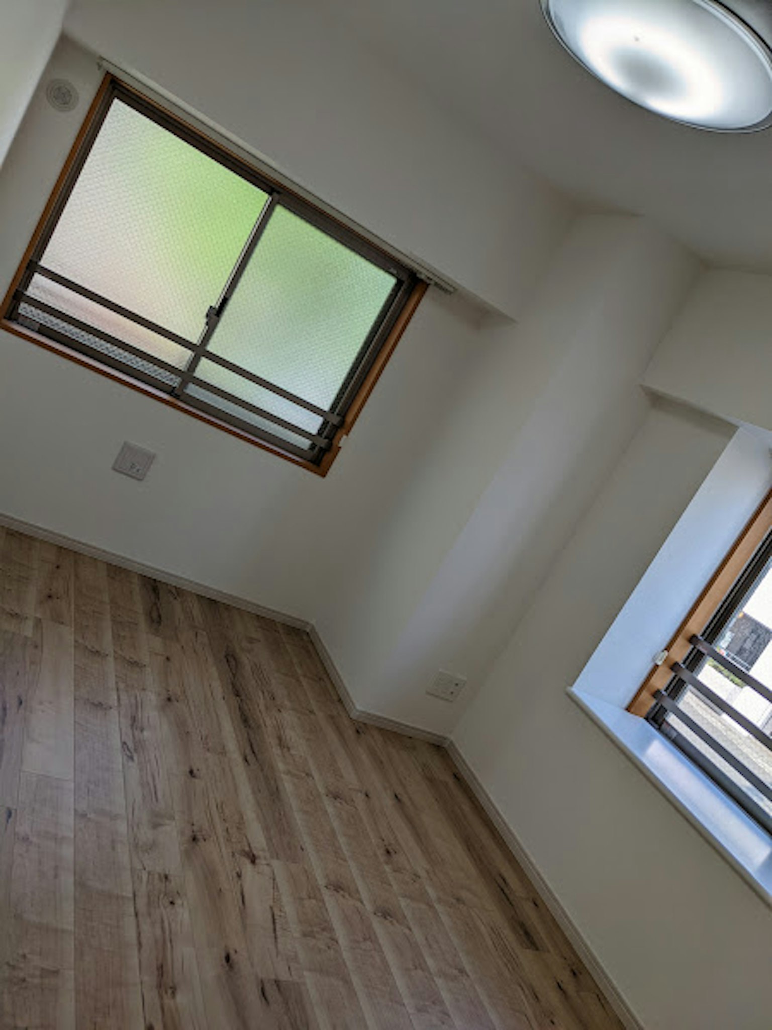 Helles Zimmer mit Holzboden und Fenstern