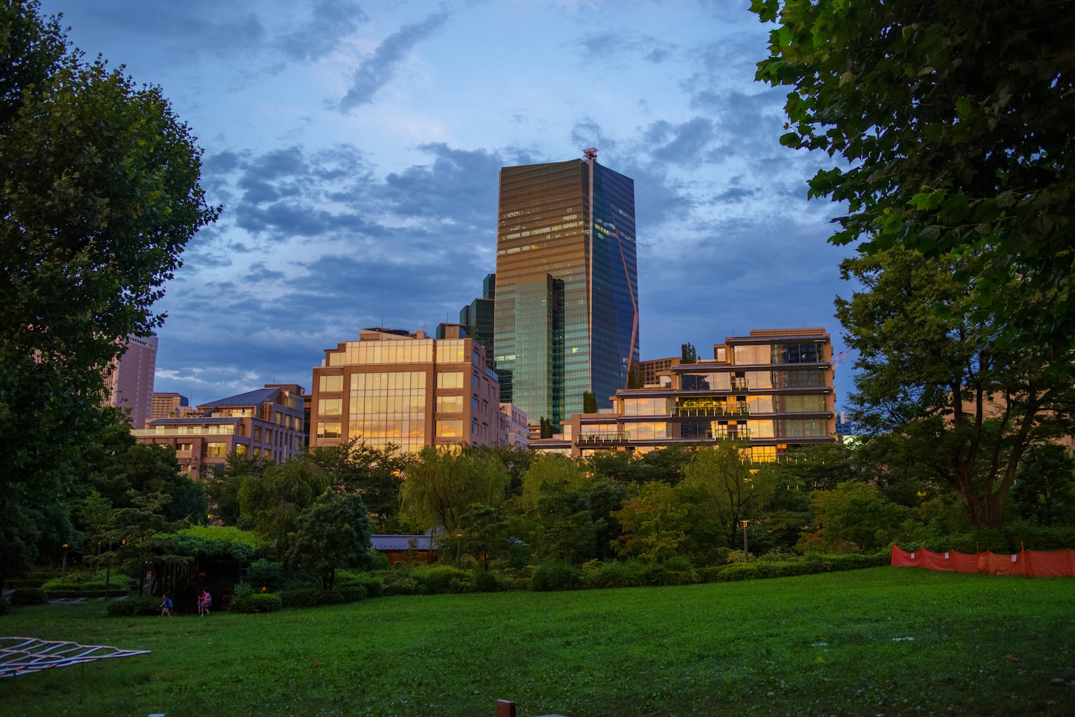 Twilight view of a park with modern buildings