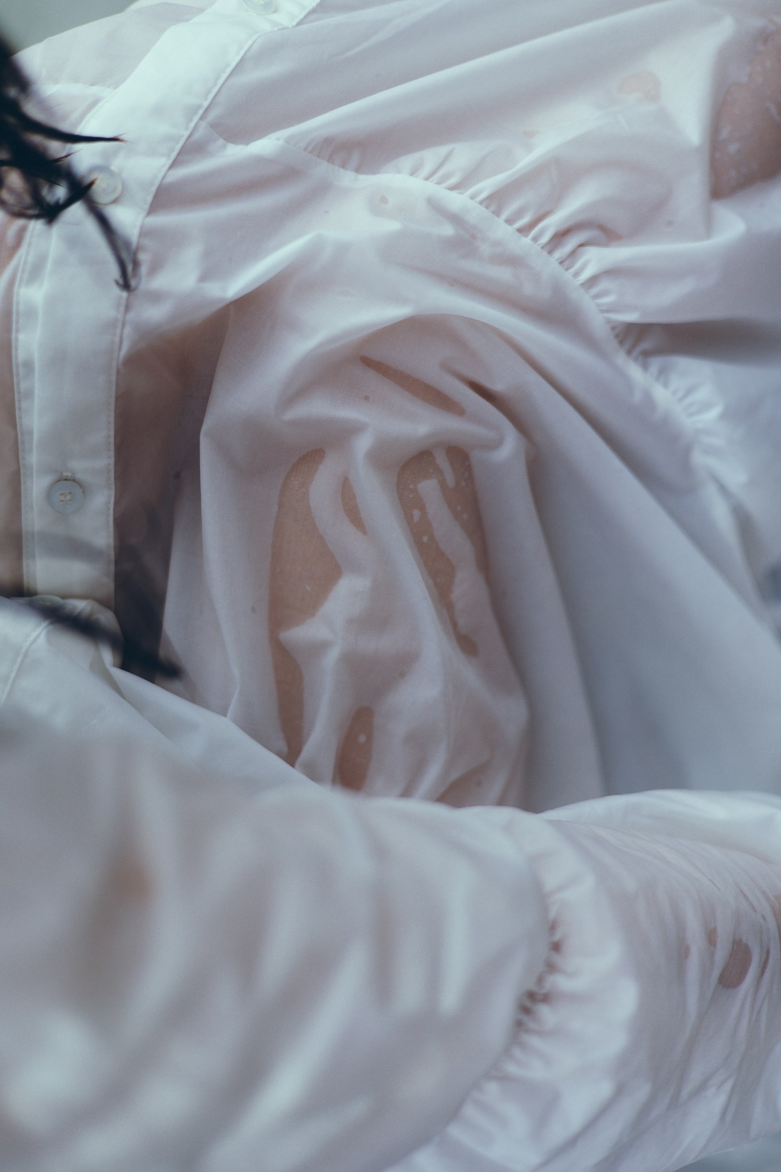 Close-up of soft white fabric dress highlighting wrinkles and texture