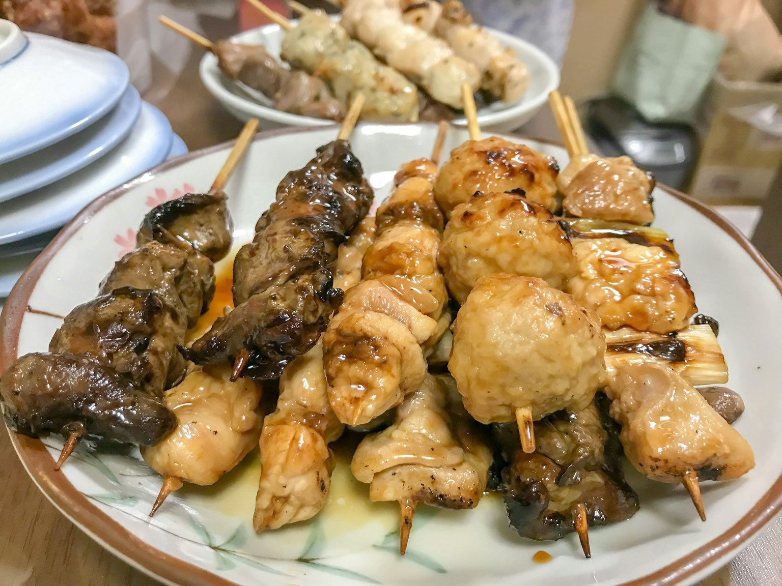 A plate of grilled skewers featuring various types of meat