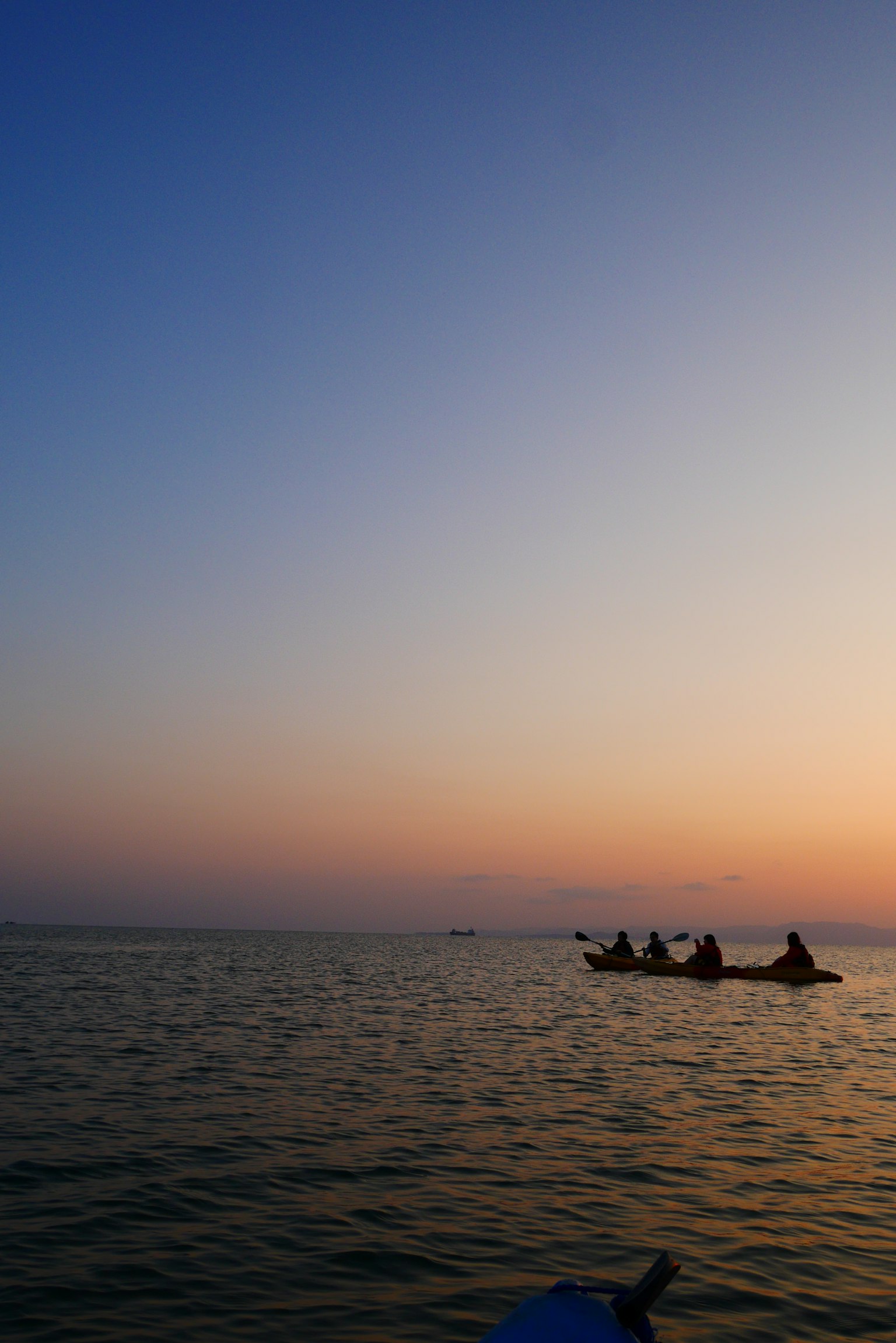 Silhouette of fishing boats on a sunset ocean