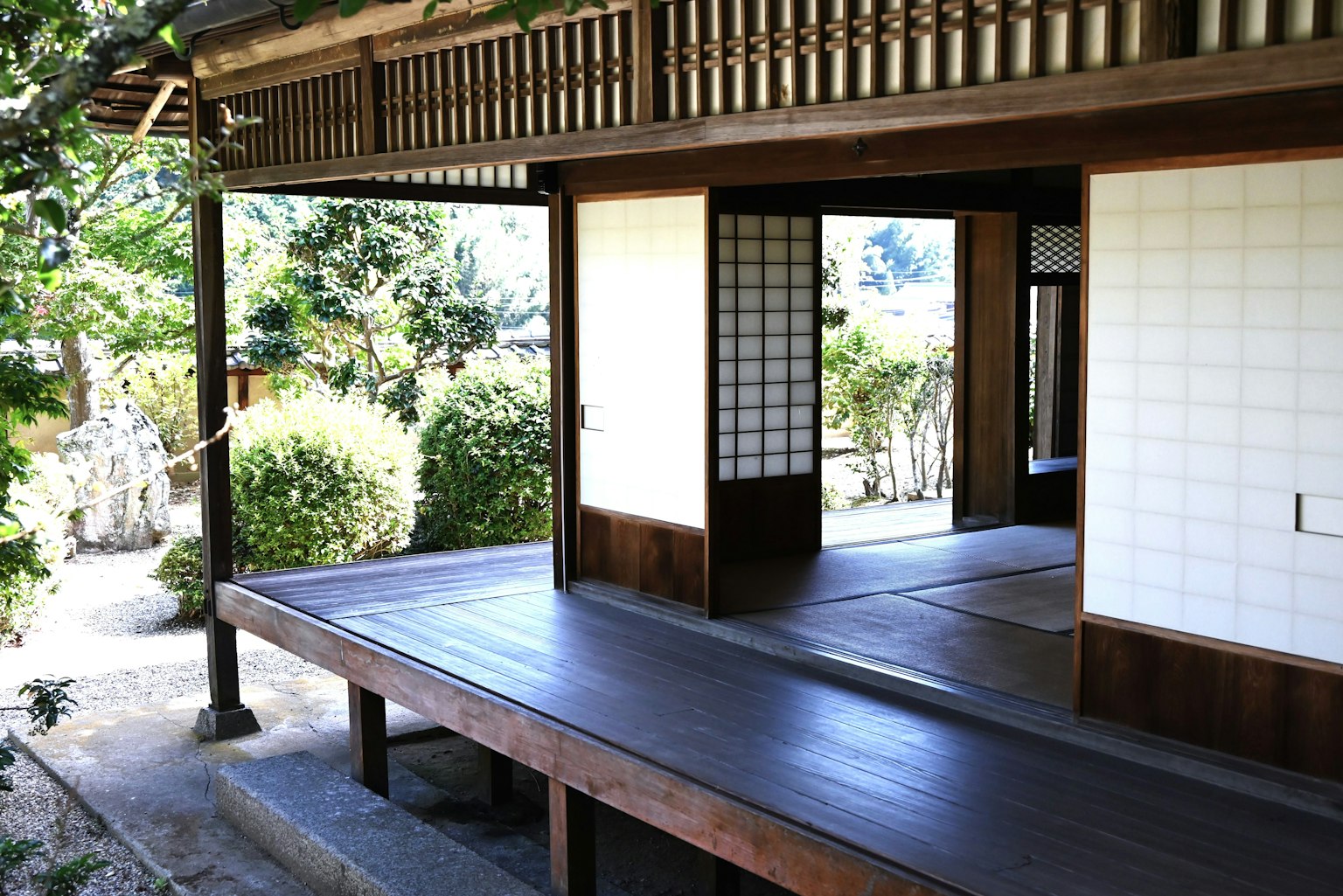 Traditional Japanese house exterior with wooden deck and shoji screens