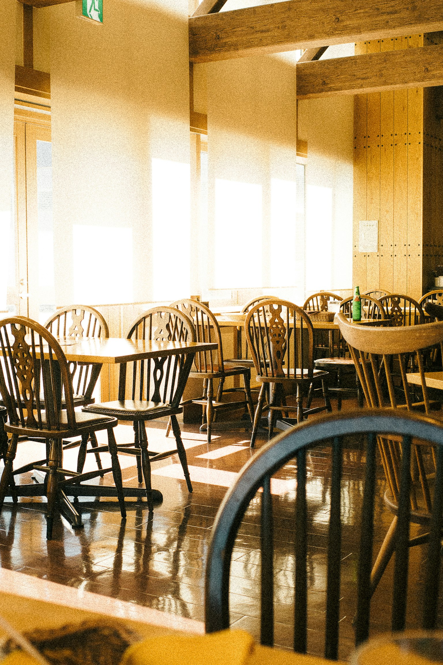 Bright restaurant interior with wooden chairs and tables