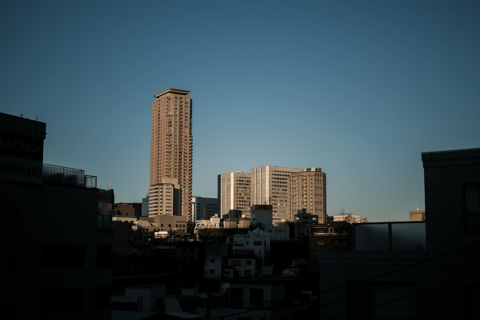 Urban skyline featuring high-rise buildings against a blue sky