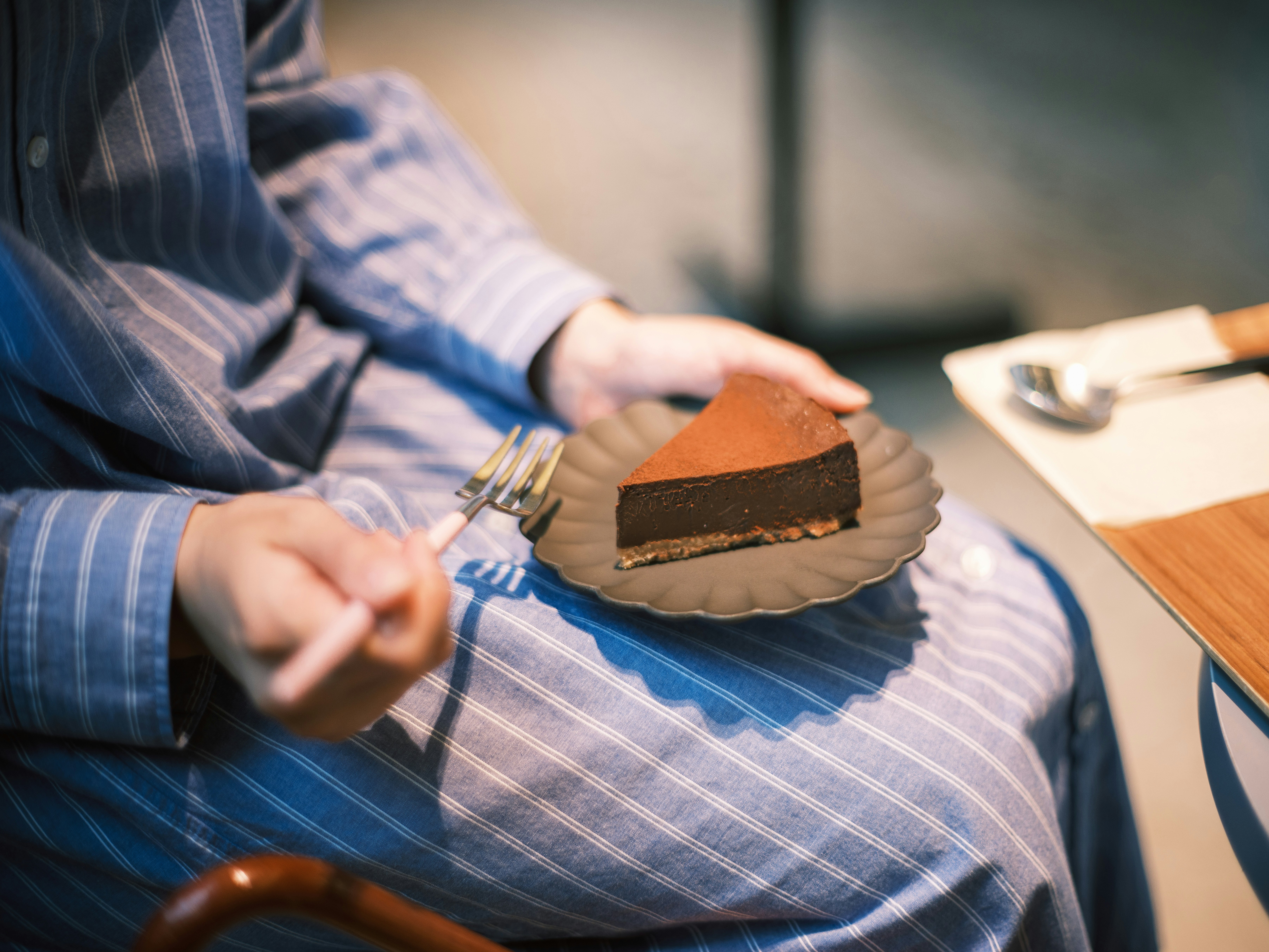 tea time with a slice of cake being handed over and a table napkin