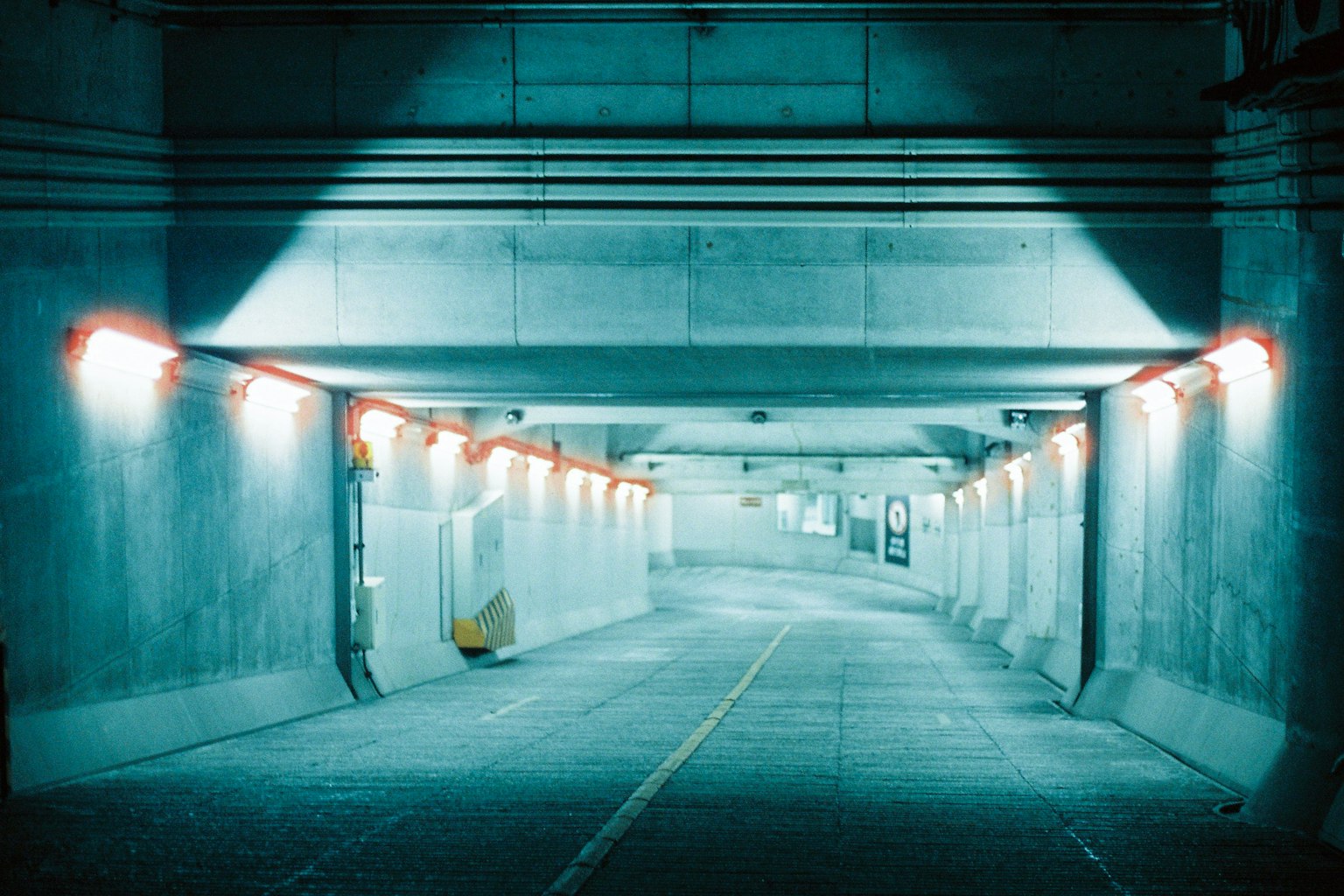 Curved tunnel interior with blue lighting