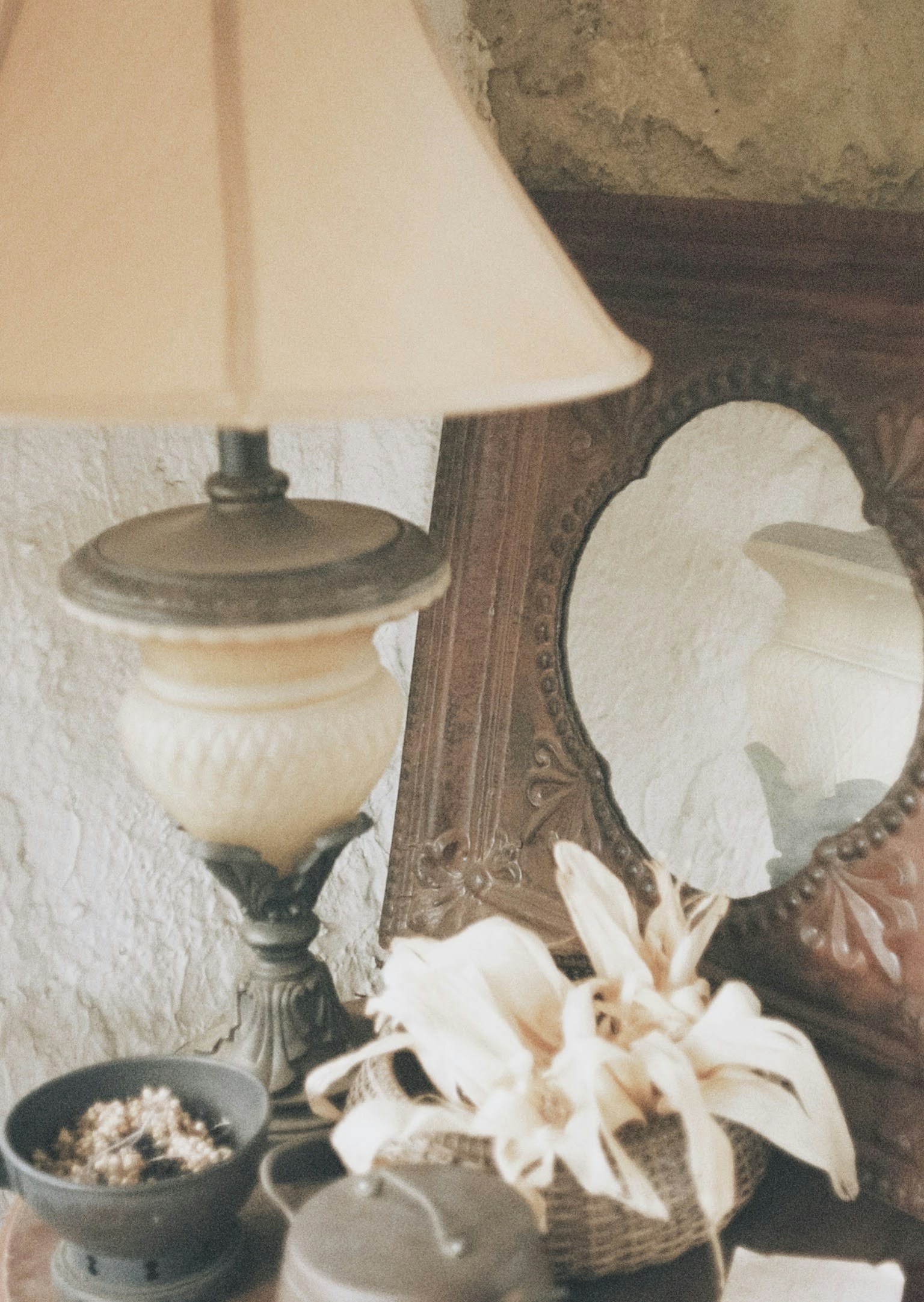 Still life scene with a lamp and a mirror on a table