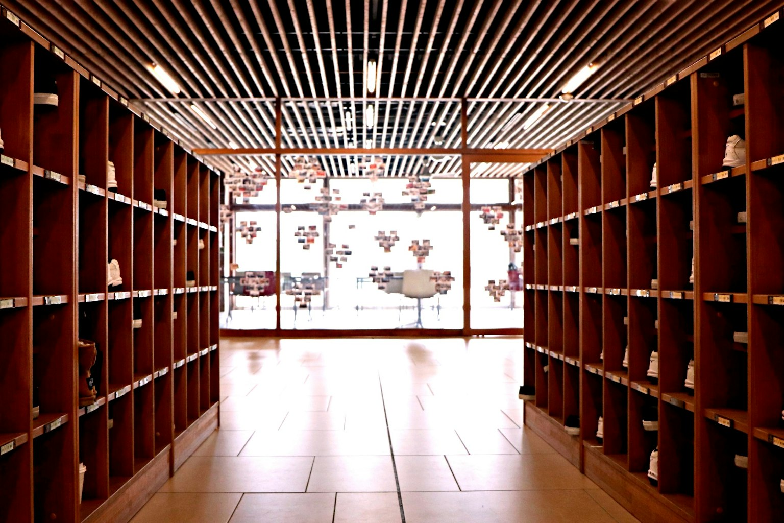 Interior space with modern shelving units leading to large windows showcasing outdoor views