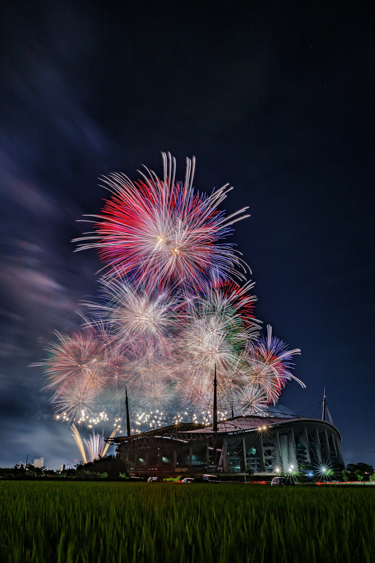 Colorful fireworks illuminating the night sky above a stadium
