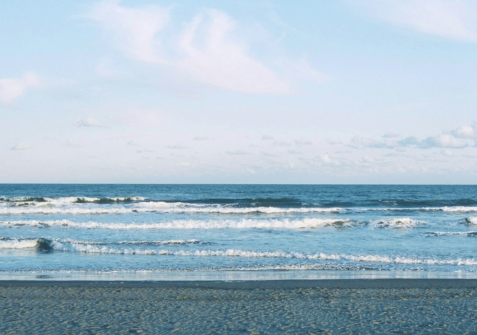Beach view with blue ocean and gentle waves