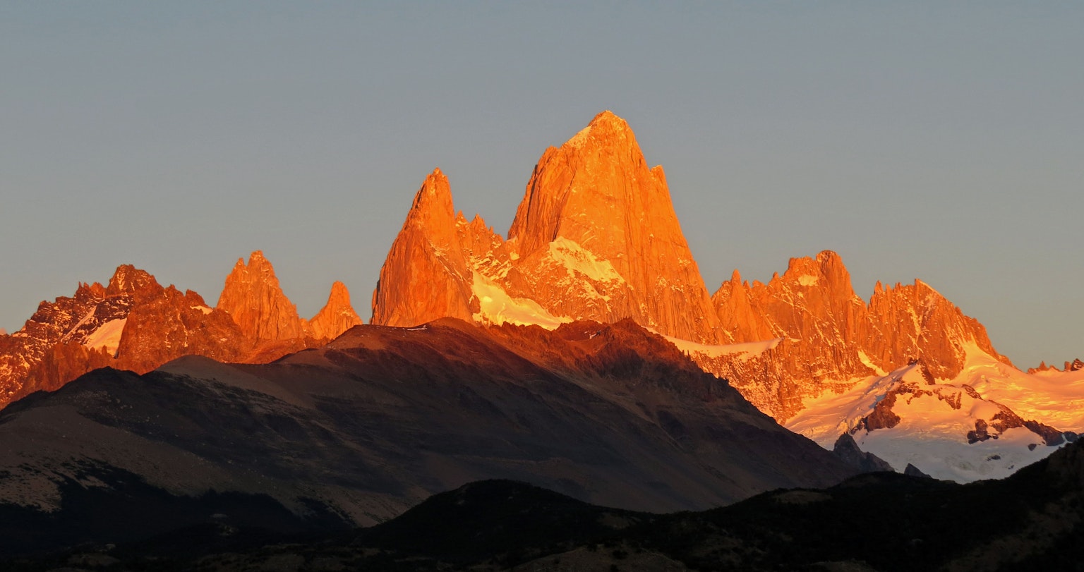 Dramatic view of the Torres del Paine mountain range illuminated by sunset